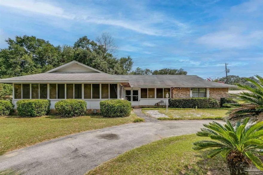 New roof and water heater before closing!  This well-maintained home is located on 1/2 acre with a circular driveway and lots of palm trees.  The galley kitchen opens into the breakfast nook that overlooks the private backyard.  The custom cabinets are in both the kitchen and the oversized laundry room.  The dining area is right off the kitchen which would make it perfect for entertaining.  Cathedral ceilings in the living room make it feel open and airy.  Brand new LVP flooring has been recently installed throughout the home.  The spacious backyard has a covered patio with a storage building and the side entry oversized garage opens right into the laundry room.