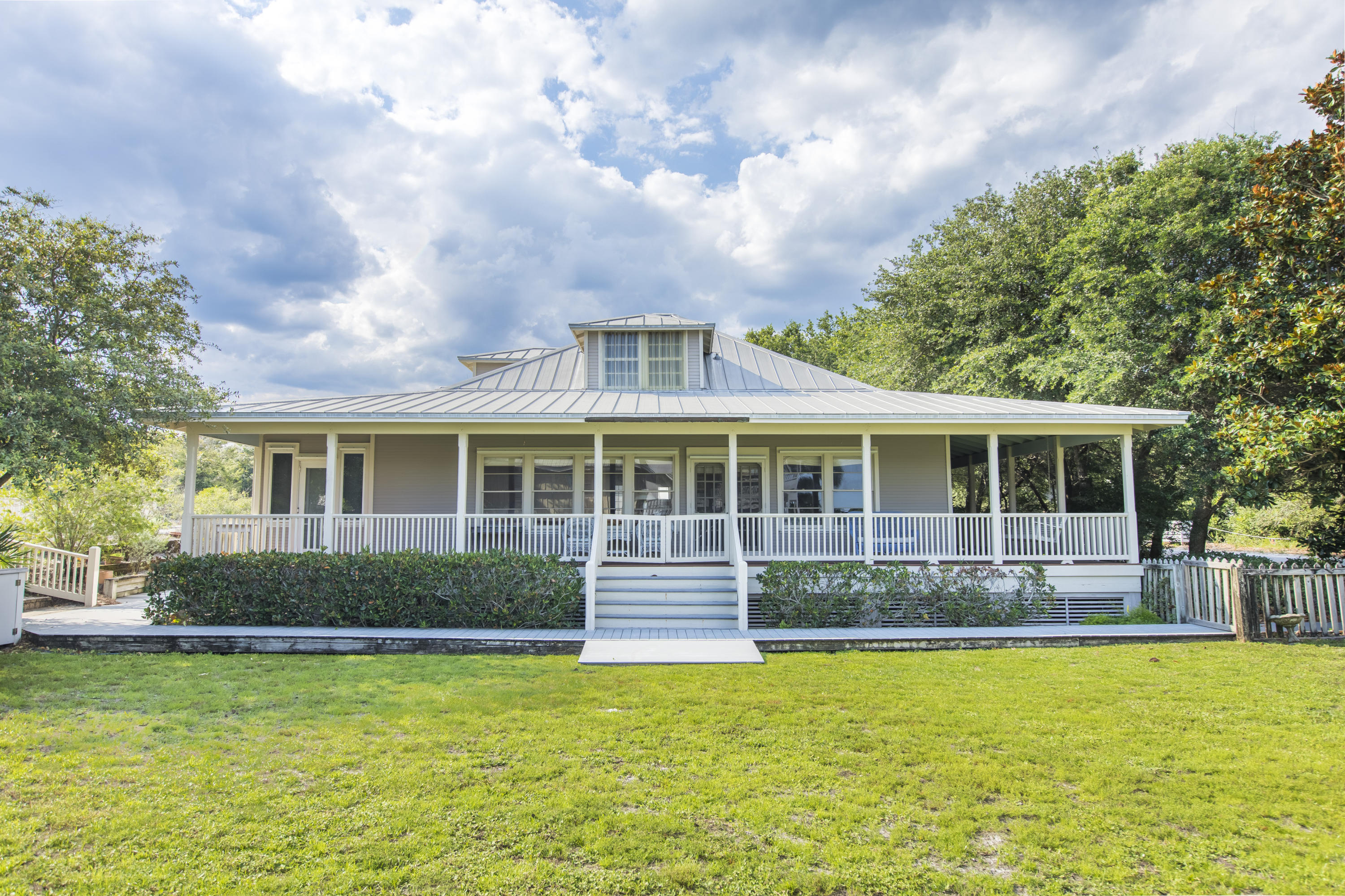 This is only the second time in 100 years that the opportunity to own this four lot estate filled with history in the heart of Old Grayton has come around. The Murray House, as it is fondly known, was not on the open market when it was purchased by the current owners, a family with generational ties to Grayton. They hired O.B. Laurent Construction to helm the renovation of the unique 1920's cottage. The two year long project began in 1991 was followed by the construction of the carriage house in 1996. The main house kitchen was later renovated and the pool was added in 2005, joined by the Hufham Farris built pool cabana two years later. One of the special features of this 6 bedroom + bunk room property is its spacious amount of open area.