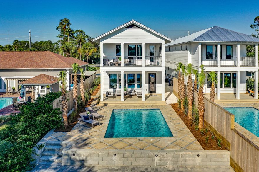 Enjoy sunset views spanning the tranquil waters of North Lagoon in Panama City Beach. This newly constructed home offers 2800 square feet of living space, 4 bedrooms with 3 full baths & powder room. Enjoy waterfront living with easy access to the sugar sands of the Emerald Coast and only minutes from St Andrews State Park, shopping and fine dining. This is a true boater's paradise with a private dock and access to the open waters of the Gulf of Mexico.Fusing urban and coastal styles, this masterfully designed and thoughtfully outfitted residence offers high ceilings, stunning, wet cast stone flooring, open concept living and unique touches throughout. From whitewashed brick interior walls to cypress accent ceilings, no detail was spared to warm the home, and the heart.