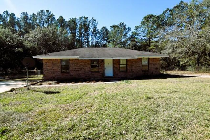 This charming brick home offers 3 bedrooms and 1.5 situated on a spacious 1 acre lot with partial chain link fencing, the property provides a peaceful setting with room to enjoy the outdoors, including enough room for a pond in the backyard. Inside, the home features vinyl plank flooring throughout, neutral paint tones, updated lighting, and ceiling fans. The kitchen was renovated in 2019 with refinished cabinets, updated countertops, backsplash, and appliances. Both bathrooms were updated, and popcorn ceilings were removed. Additional improvements include a parking pad, driveway. Conveniently located minutes from I-10 and about 45 minutes to white sandy beaches. Call to take a look at 2784 Meredith Lane today.