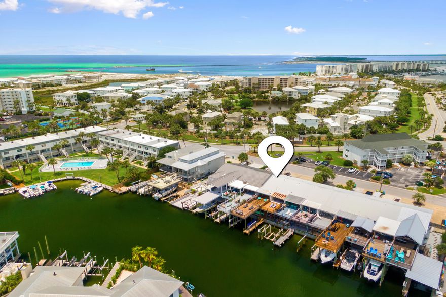 Located on desirable Holiday Isle, this spacious unit features rich wood flooring in the main living area and master bedroom, brand new carpet in the guest rooms, and travertine tile in the kitchen--paired perfectly with sleek stainless steel appliances. New A/C unit and air handler, deck extension, and hurricane windows and doors are an added bonus as well.Step out from the main living area onto a large private deck that overlooks the peaceful canal, offering easy access to the harbor for boating and water activities. The deeded deep-water boat slip can accommodate vessels up to 35' in length with a generous 12'7' width--ideal for serious boaters. With its prime location, modern finishes, and unbeatable water access, and low HOA this townhome is a rare find on the coast.

Don't miss your chance to own a piece of paradise! Buyer to verify all dimensions.