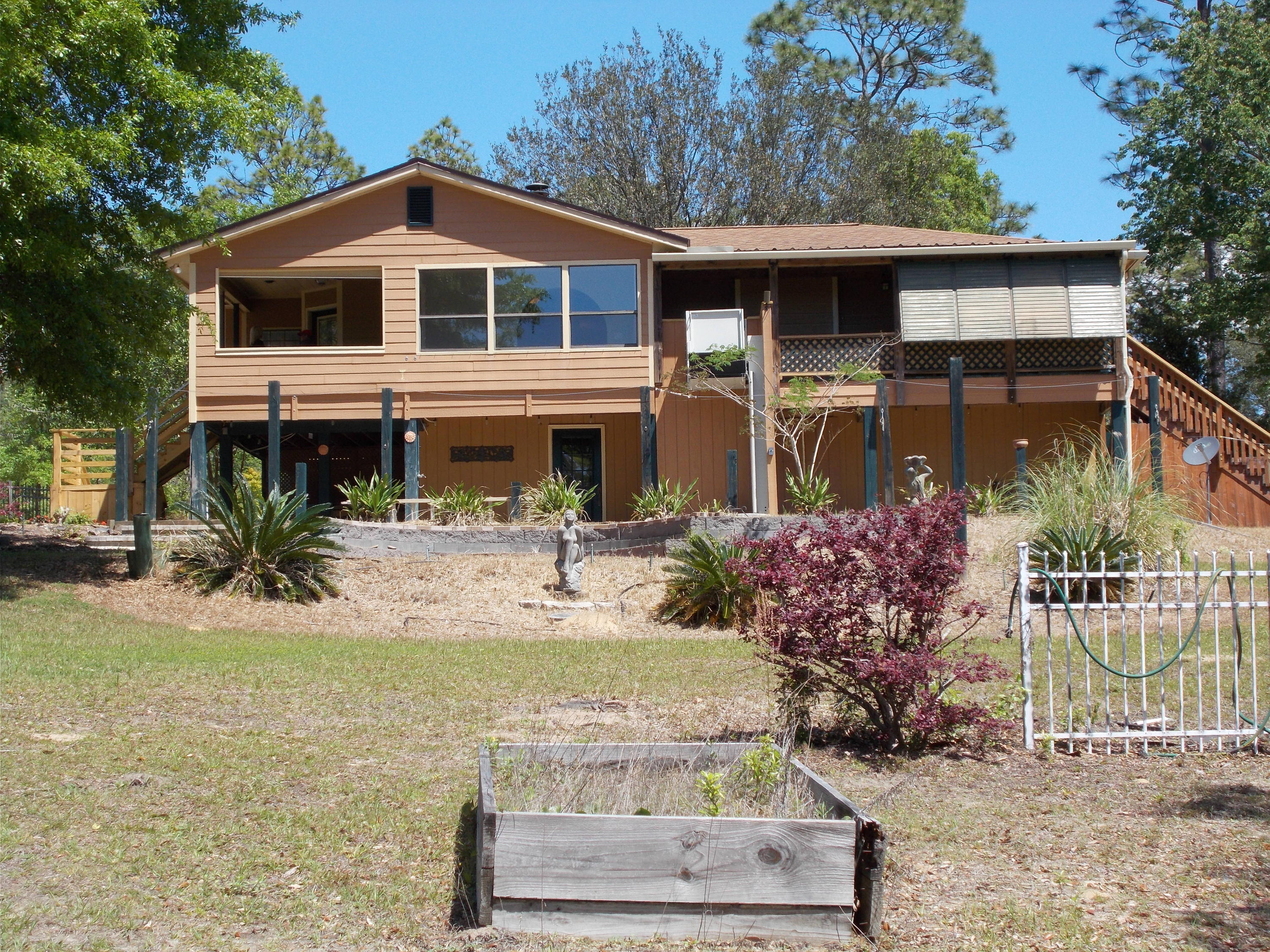If you are looking for Peace and quite. This is it-Truly Must See Property ! HUGE personal Car Shop/garage with open covered work areas as well. .Office inside PLUS a HUGE workshop for all of your woodworking equipment or storage. These are a must see to appreciate. NEW ROOF GOING ON NEXT WEEK WITH 50 YEAR TRANSFERABLE WARRANTY-May 13-17-2019 Both of these building are newer metal Buildings with finished floors. AND there is the Lake where you can enjoy fishing, canoeing or just a nice swim. All of this not to mention the 2 bed 2 bath Home Started in 1993 with continual work to keep it upgraded.(a 3rd bedroom currently used as a den/office)Home is Hardie Board ,Wood Laminate Floors This home even has a elevator onto the rear deck installed by Bella Elevators.. 343 Feet on water