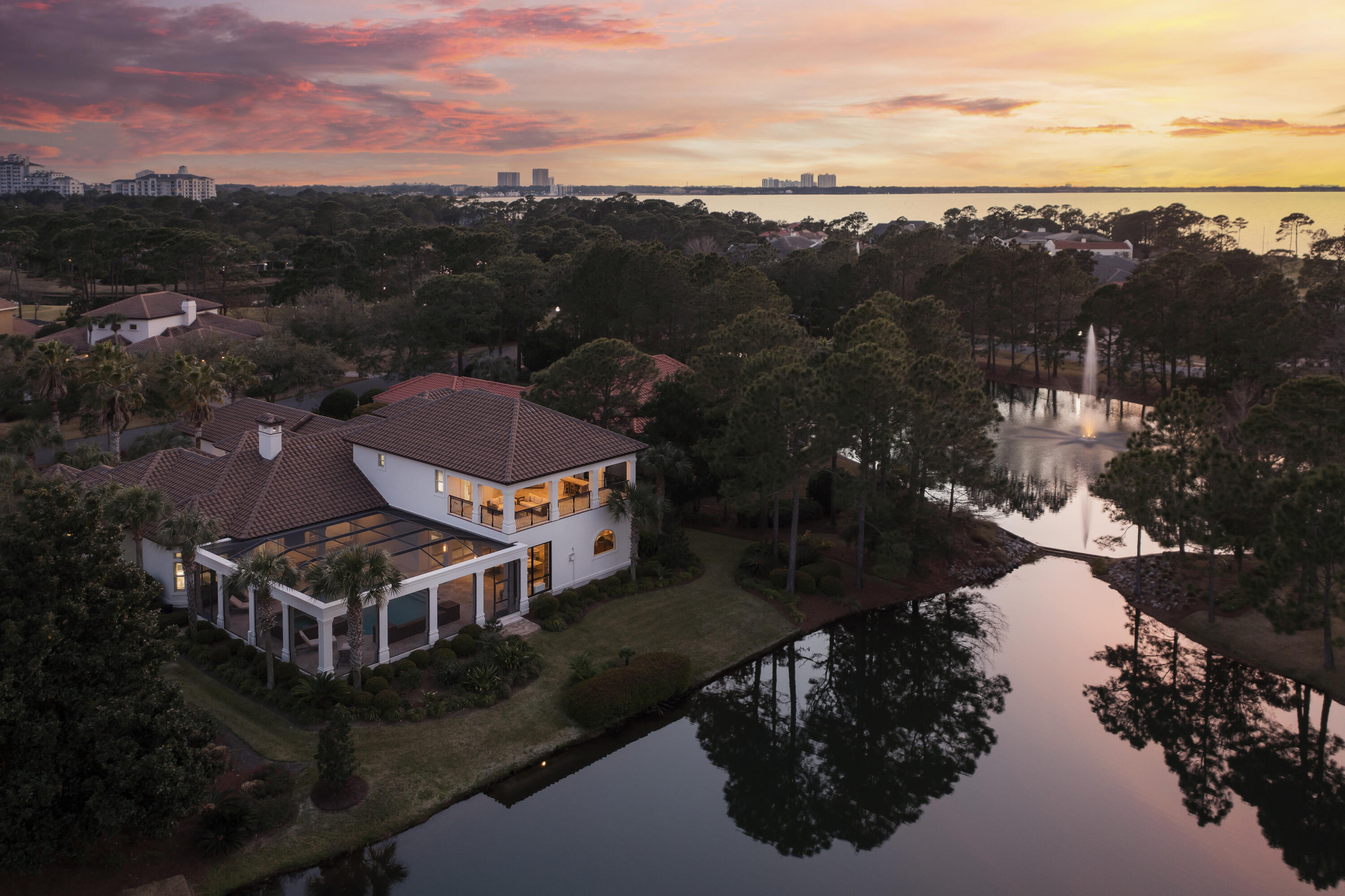 This gorgeous lakefront home located in the exclusive gated community of Burnt Pine, in Sandestin's Golf and Beach resort, was fully remodeled and renovated with high end finishes in 2021-2022. Exquisite detail and craftsmanship complement this beautifully designed villa with soaring ceilings. You'll find it is perfect for both family life and for entertaining in the most beautiful style. A private master wing, a separate guest suite, an office and spacious living areas are on the first floor.  Enjoy the temperature-controlled wine cellar with your family and guests. The indoor and outdoor living areas flow seamlessly together, and you will experience the best of Florida resort-style entertaining in the outdoor living space, which includes a summer kitchen and stone fireplace