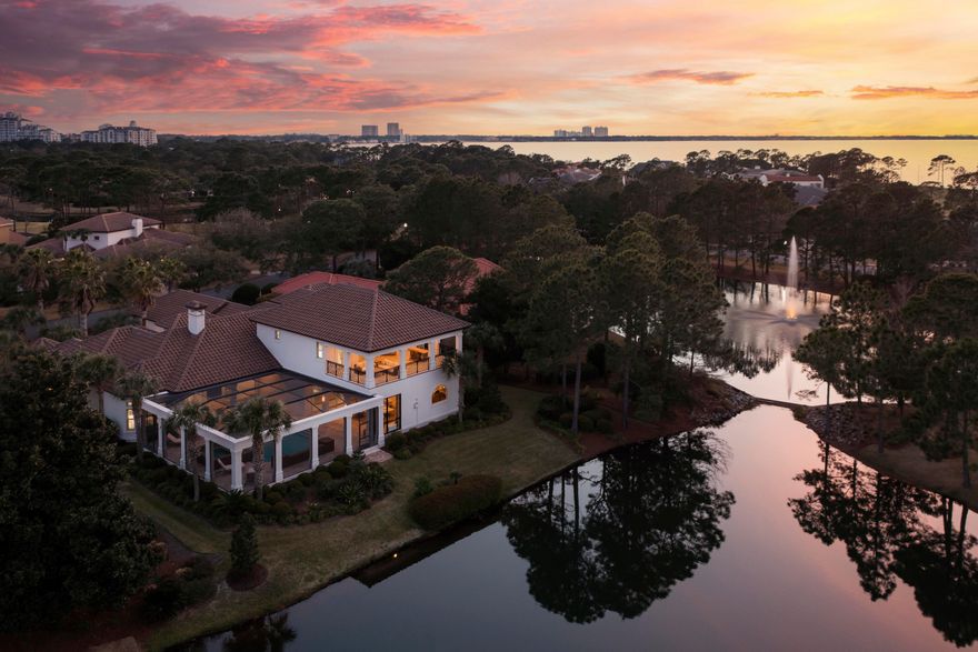 This gorgeous lakefront home located in the exclusive gated community of Burnt Pine, in Sandestin's Golf and Beach resort, was fully remodeled and renovated with high end finishes in 2021-2022. Exquisite detail and craftsmanship complement this beautifully designed villa with soaring ceilings. You'll find it is perfect for both family life and for entertaining in the most beautiful style. A private master wing, a separate guest suite, an office and spacious living areas are on the first floor.  Enjoy the temperature-controlled wine cellar with your family and guests. The indoor and outdoor living areas flow seamlessly together, and you will experience the best of Florida resort-style entertaining in the outdoor living space, which includes a summer kitchen and stone fireplace