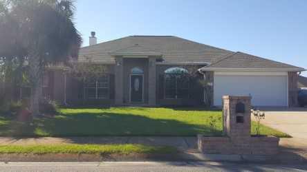 This beautiful all brick home is walking and biking distance to High School, sports fields, parks, YMCA fitness center, restaurants, and shopping and less than 5 minutes to beaches with easy access to both hwy 98 and 87. There is a den with transom double French doors and dining room on either side upon entering. Dining room could be used as desired because there is an additional bay windowed eating area overlooked from the spacious kitchen with updated stainless appliances and large breakfast bar. Past the entrance it opens to a great room with a wood burning fireplace, two large nooks, plant ledges, and a view to sunroom and large lake shaped pool. There is tile in all wet areas, pergo wood floors throughout remaining home, all living areas have tall 10ft ceilings,