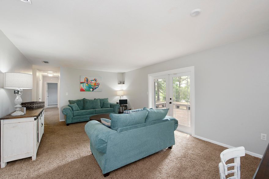 Like bird watching? Find the bird! Fly on by so you don't miss this gem!!! 47' on the lake; not in a flood zone!! This 3 bedroom, 2 bath offers two living rooms, one overlooking the lake and the other with a wood burning fireplace perfect for winter evenings. The sellers have just completed new upgrades to include new interior paint, removal of popcorn ceilings (except in the bedrooms), New bathroom vanities installed, new carpet in the back living room, and they pressure washed the home so you just have to move in!