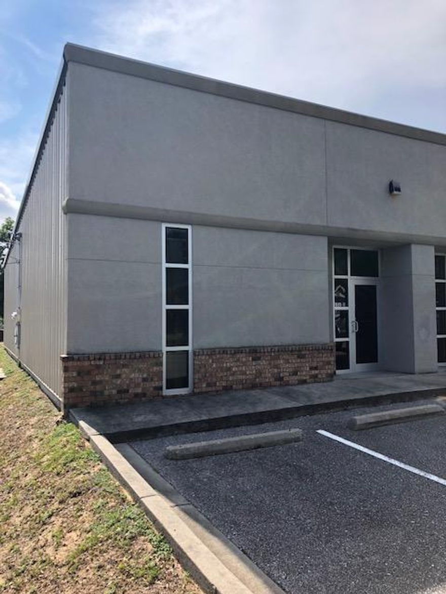 Very nicely built out metal modular building with an attractive brick and stucco storefront facade. To Building pull up parking. sidewalks, front door, rear personnel door and a grade level roll up door. Nice Wide Open Bay (1400 SF) with small office(100 SF) /RR built out. The office is easily expandable, if needed.Located on the Western edge of Downtown Pensacola. Surrounded by a mix use of residential and commercial businesses. Just off Garden St., the main downtown thoroughfare.