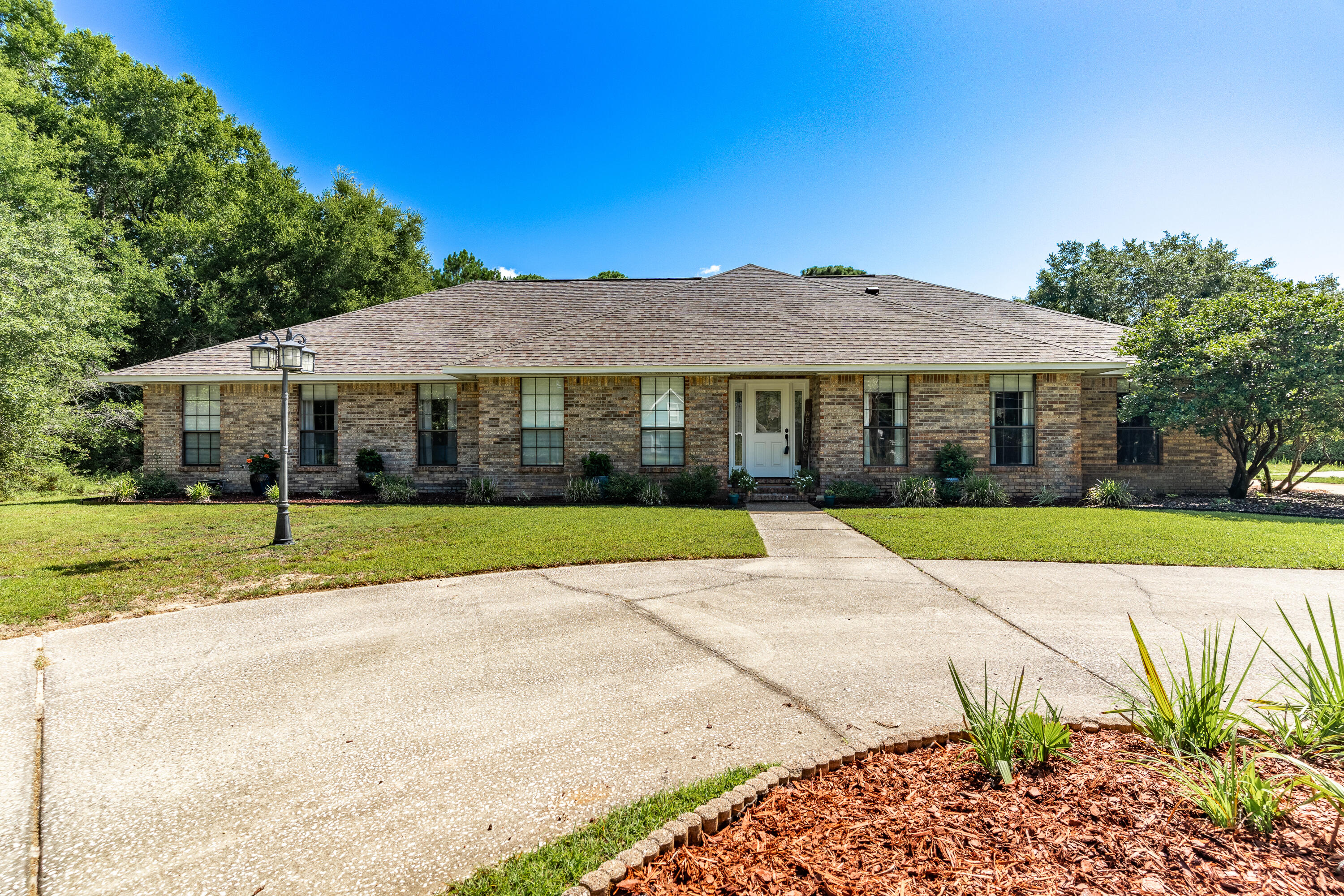 Welcome to this beautifully maintained and spacious brick home, perfectly situated on almost 3/4 of an acre in a quiet cul-de-sac in the highly desirable Holley by the Sea community. Featuring 5 generously sized bedrooms, 3 full bathrooms, a sparkling screened-in pool, this home offers something for everyone.Upon entry, you're greeted by a welcoming foyer flanked by a formal dining room and a formal living room, ideal for entertaining. The main living area boasts a stunning brick, wood-burning fireplace and provides direct views and access to your private backyard oasis.The kitchen is designed with both style and functionality in mind, showcasing granite countertops, stainless steel appliances, ample cabinet space, and a charming breakfast nook. The luxurious primary suite offers a private pool access and a fully renovated en-suite bath complete with quartz countertops and a walk-in tile shower.
Two of the spacious guest bedrooms share a beautifully updated Jack-and-Jill bathroom, while a third guest bedroom and full bath are tucked away perfect for guests or extended family. The 5th bedroom off the kitchen adds even more flexible space, ideal for a home office, playroom, or media area.
Outdoors, the screened-in pool area provides a serene space for both entertaining and relaxation. You'll also enjoy a 16'x40' workshop complete with electricity and HVAC, a 14 x 14 storage shed, as well as an outdoor fireplace perfect for year-round enjoyment.
This exceptional home combines indoor comfort with outdoor living and is a must-see for any buyer looking for space, privacy, and amenities in Holley by the Sea.
The roof was replaced in 2020. Water heater 2021