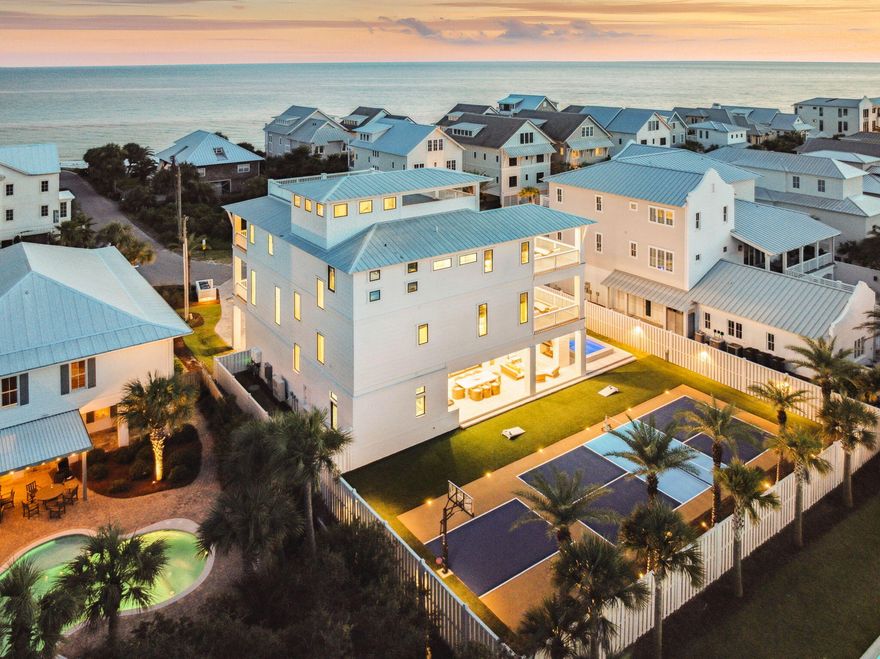 Welcome to 329 Winston Lane, a home where design pedigree and coastal lifestyle converge in extraordinary fashion. Rising three stories above Inlet Beach and crowned with an expansive 4th-floor rooftop deck, this residence offers sweeping Gulf views, hand-selected finishes and furnishings curated by Melanie Turner Interiors of Atlanta, and a track record of performance with rental revenue nearing $500,000 this year. It is a property that marries beauty, lifestyle, and investment like no other.The ground floor sets the tone for entertainment. A game room with wet bar and pool table opens through expansive sliding doors that erase the boundary between indoors and out, creating one seamless living space. Here, a covered outdoor kitchen with natural gas grill, alfresco dining, and fireplace lounge sets the stage for unforgettable gatherings. Beyond, the private pool and spa glisten in the sun, while the rare luxury of both a pickleball/tennis court and a basketball court bring energy and play to every gathering. Two private guest suites provide comfort and privacy at day's end.

On the second level, light and space define the great room. Glass walls frame Gulf views as the living area flows effortlessly to a wide balcony. The chef's kitchen, equipped with high-end appliances and a generous island, doubles as the heart of the home. The adjoining dining space welcomes family meals and celebrations alike, while the junior primary suite with private balcony offers a refined retreat of its own.

The third floor reveals the primary suite, a retreat of rare scale and sophistication. Gulf-facing views pour through walls of glass, creating a backdrop that shifts with every tide and sunset. Spacious and serene, this suite was crafted as a world apart: a place where mornings begin with salt-kissed breezes, evenings dissolve into painted skies, and every detail whispers of quiet indulgence. Three additional bedrooms, including two king suites with balconies and a playful bunk room, complete this level along with a coffee bar and laundry for ease of living.

Above it all, the 4th-floor rooftop deck delivers the pinnacle experience: a horizon of turquoise waters by day and a private theater for unforgettable sunsets each night.

With an in-home elevator, multiple balconies, and parking for four vehicles, 329 Winston Lane is more than a home. It is a statement, a gathering place, and a legacy  a place where curated design, coastal living, and extraordinary returns meet on one of the most coveted stretches of 30A.