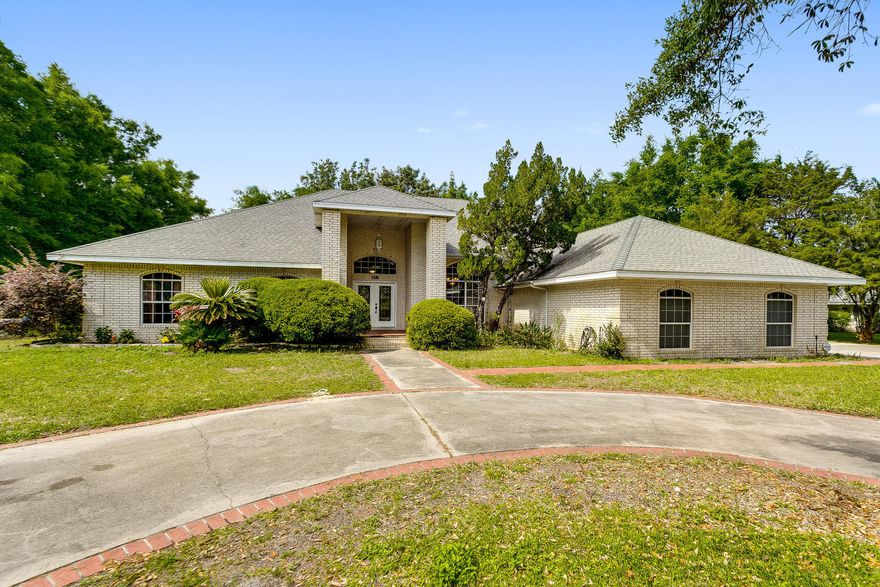 Don't miss this opportunity to own a home in the heart of Gulf Breeze Proper. This all brick home is nicely situated on an half acre corner lot in the Prestigious Bay Cliffs Community. Approx 3500 sq. ft. with 4-bedrooms and 4-baths, high ceilings. Formal dining room, huge living room with 11-ft ceiling and built-in entertainment center and gas remote fireplace. 37-ft long sun room across back of home. Master bedroom is 18x25. Master bath has 2 walk-in closets, large separate shower, whirlpool tub and stained glass window. Spanish lace gated back yard, stone water fall and pond with brick patio. Come see this home today!