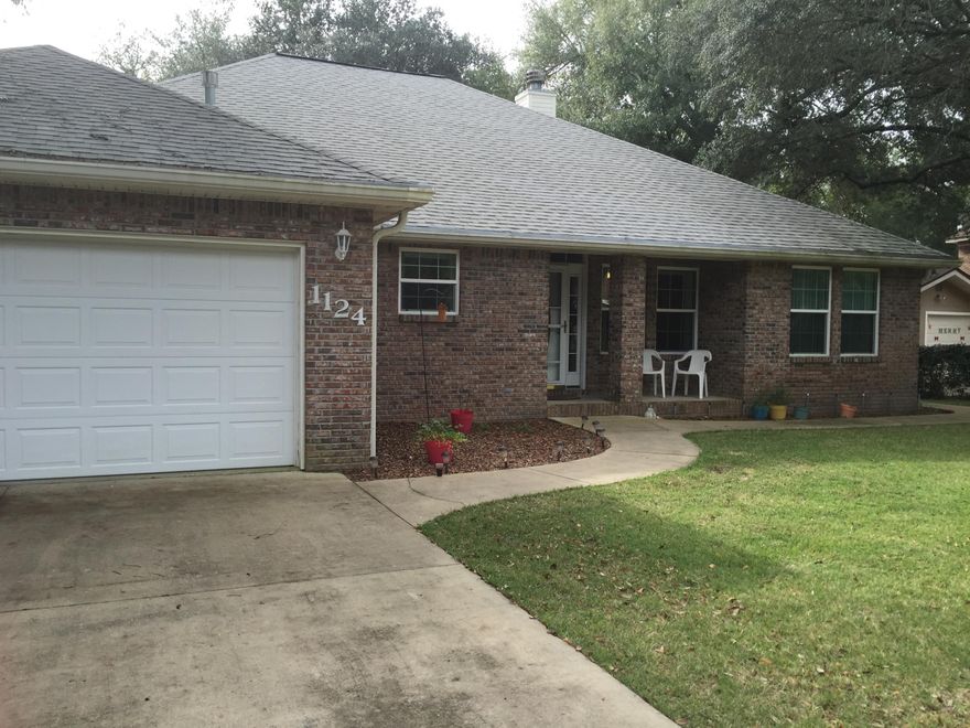 Right in the heart of Niceville, just 13 minutes from Eglin AFB.,this custom built home is situated on two lots with mature trees and a work shop and fire pit area. Windows are all impact resistant. The open floor plan has a kitchen with white cabinets, new appliances, large pantry and breakfast bar with granite counter tops, and newtile floor. The living room is open with crown molding, surround sound, wood burning fireplace with gas starter, and sliding glass doors leading out to a large screened back porch that is 55'x10'. Dining area is adjacent to the kitchen with crown molding. Split bedroom plan, on one side there are two bedrooms and bathroom. The spacious master bedroom on the other side, also has sliding doors to the porch. The master bath, has double vanity and sitting area