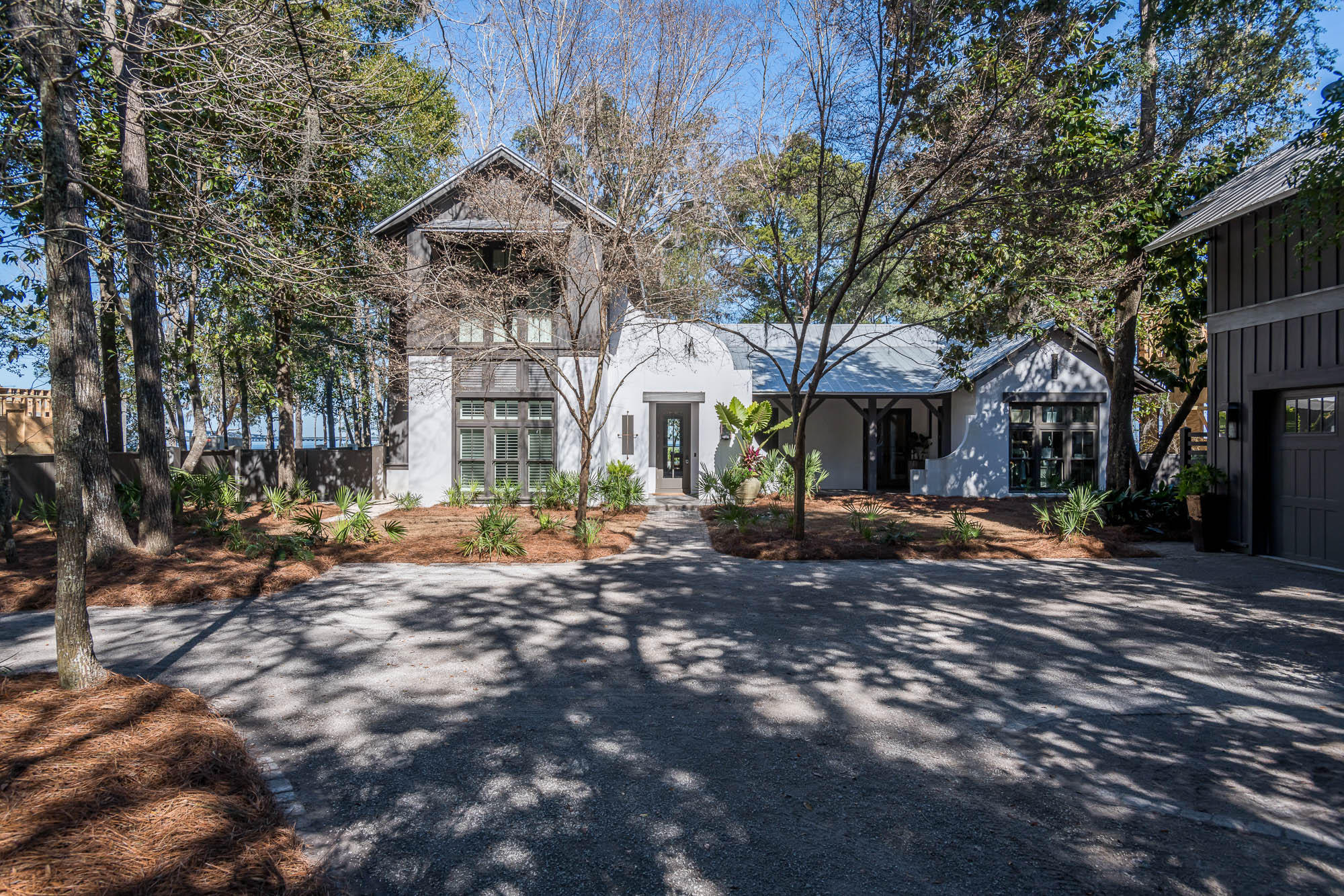 This stunning, custom designed home by architect Tammey Massey is nestled within the serene gates of The Estuary on 106ft of bay frontage. This bay front, coastal estate was thoughtfully designed and crafted with fortified concrete block constructed and built by the Arkon Group. The home offers an elegant open floor plan with a foyer that immediately offers direct bay views as you enter the living room, open dinning, and kitchen. The home has reclaimed distressed heart of pine floors throughout, vaulted ceilings, and open shelving in the custom designed chefs' kitchen that offers incredible panoramic views while mastering your favorite meals in this stunning kitchen.