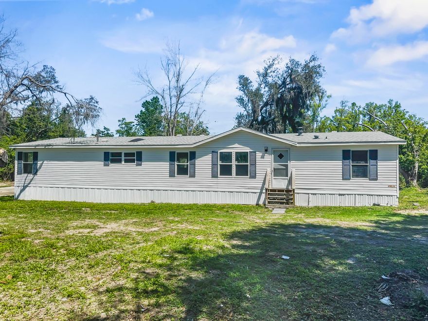 You'll instantly fall in love with this spacious 4 bedroom/2 bathroom manufactured home! With 1,890 square feet of living space on an oversized lot with a private pond, this property is a fishermen's dream! There is a 40 ft. dock that could use a little work, but the pond is stocked with bass! The kitchen is spacious and has an island and a new stove. It has a bonus room off of the master suite and the bathroom features a double vanity, garden tub, and separate shower. The roof was replaced in 2018. The AC was recently replaced, and the Seller just replaced all the carpet and painted ceilings and walls. The family room also features a wood burning fireplace. The home sits on three lots making it a little over an acre and is located on the end of a paved road.
