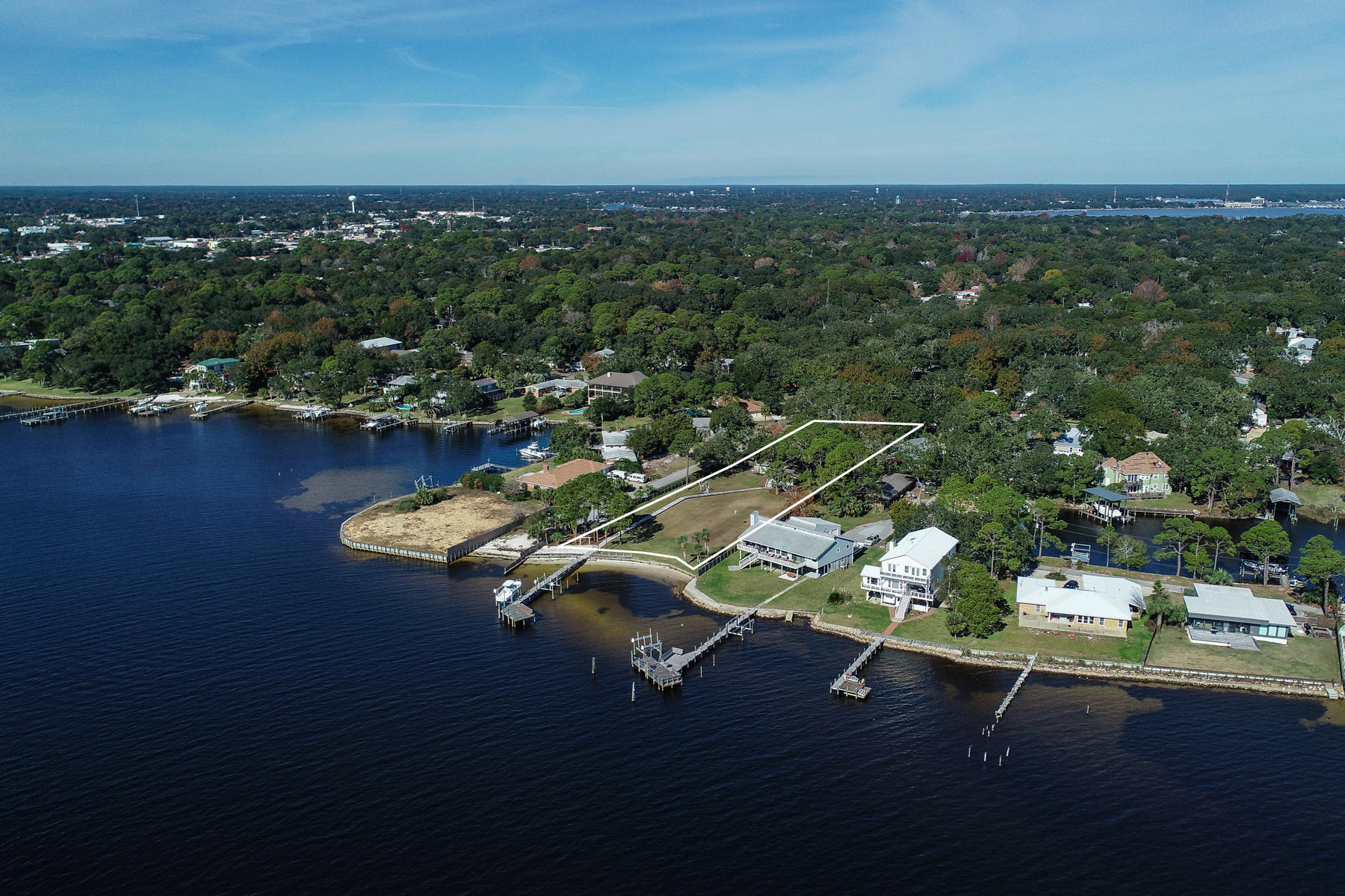 The prize waterfront lot of Elliott Point on Brooks Street has become available. Own this rare 1.56 acre deep water piece to build the ultimate estate. The professionally landscaped manor-like yard with full privacy hedge has a meandering 360' pier to the waterway and a 125' dock. The deep, deep water off Santa Rosa Sound and Choctawhatchee Bay is suitable to berth a 50'-60' vessel. There is a possibility to split the lot into four to six parcels, or consider subdividing off one or two lots to sell while building a superlative waterfront residence. There is a seawall and two boat lifts. This remarkable lot is the consummate setting to create an unequalled waterfront estate. Existing older home on site.