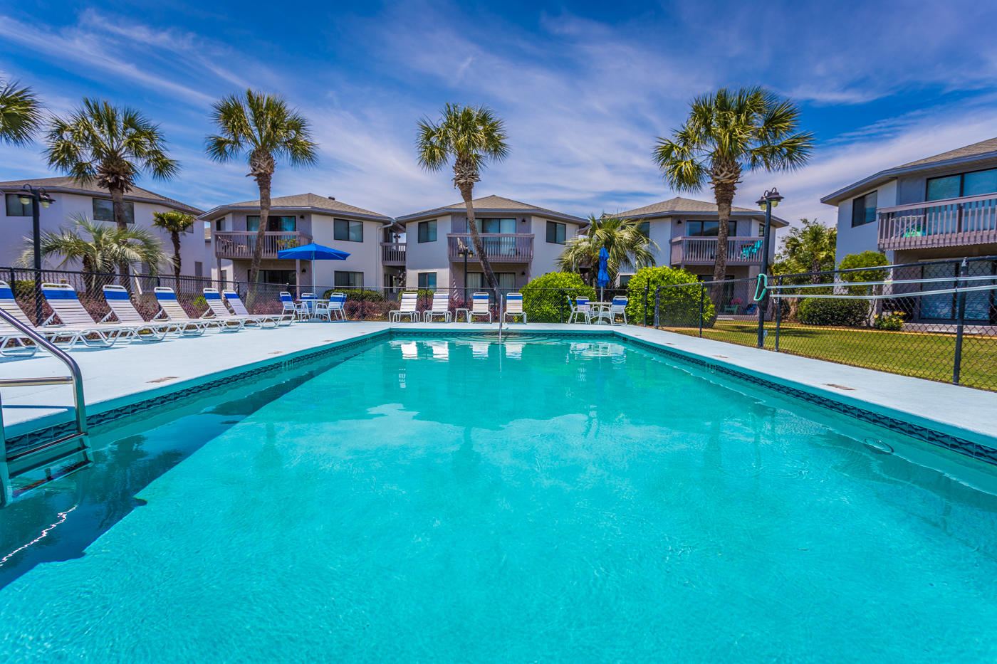Come see this newer (Phase II), upstairs quiet unit with private balcony overlooking the pool. A short stroll from award-winning white beaches and Pompano Joe's Famous Restaurant. This delightful, bright, two BR condo is located in a quiet, relaxed environment overlooking one of two pools. This quiet, private location with two-story buildings surrounded by pools and gardens, provides an atmosphere that is more relaxed than a typical condo. New Flooring, New Paint, and ready for Summer! The kitchen has been remodeled with high-end cabinets, granite countertops and all new appliances.New furnishings, linens, dishes and kitchenware turnkey to live in or rent out immediately. You'll feel like you're home in these quaint and cozy cottages. Come see it today! This one won't last long!