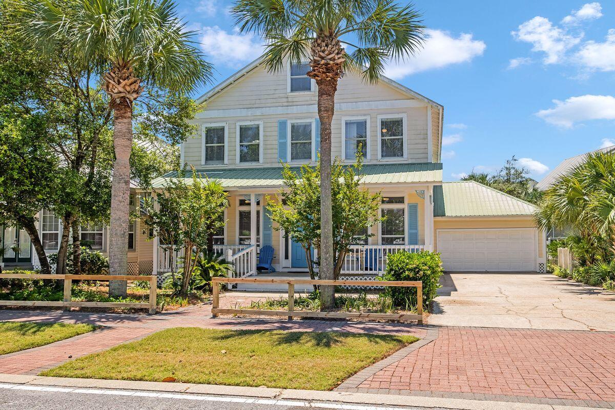 Just 500 yards from the white sandy beach and gulf waters, this quintessential Florida cottage is newly remodeled and surprisingly spacious. Set behind a white picket fence in the heart of Crystal Beach, the brick paver sidewalk leads right to the front porch, two-car garage and generous driveway for parking. Inside, the open floor plan provides a light bright space beneath a white coffered ceiling. There's ample space to put your feet up in front of the new fireplace in the sitting area or entertain in the chandeliered dining area. Cooks will love the well-planned eat-in kitchen with its attractive marine blue cabinetry and central breakfast table. Perch on high stools at the breakfast bar and enjoy cocktails while chatting with the cook.