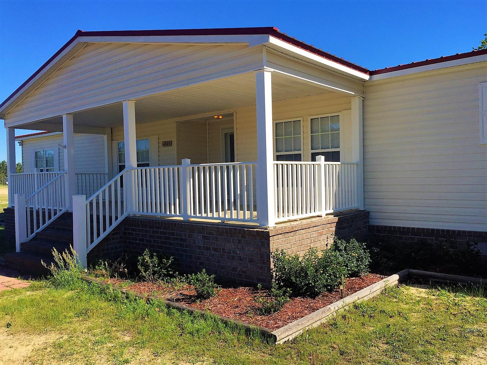LIKE NEW 4 BR 2 BA Manufactured Home with OWNER FINANCING AVAILABLE WAC - Very nice - dream kitchen, wood burning fireplace, glamour bath with garden tub, metal roof, and too many others to mention! Property is 1.4 acres on a paved road.