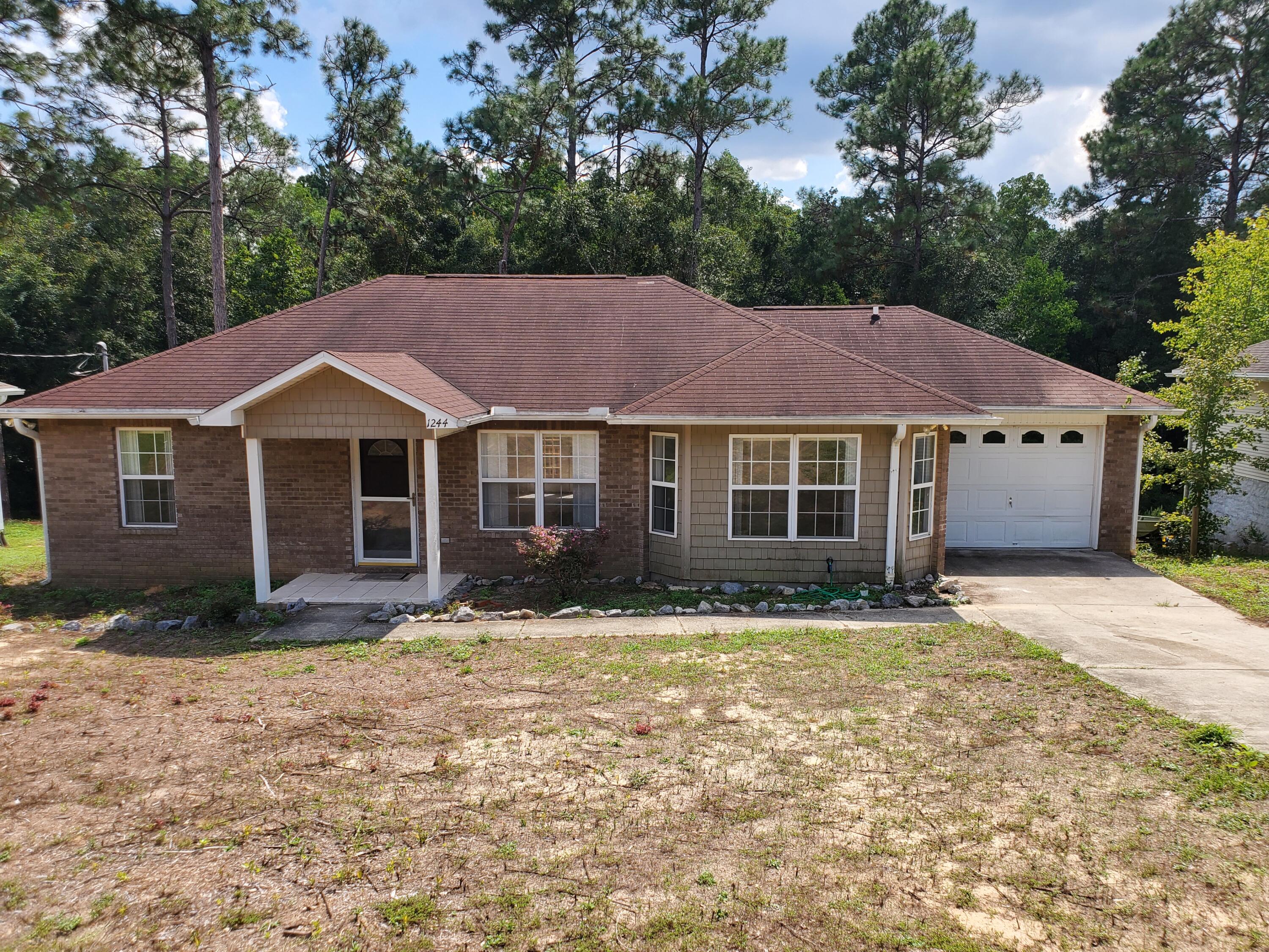 Wonderful 3/2 home with a garage in a great neighborhood. Clean and well maintained with many custom features, typically in higher priced homes. Oak kitchen cabinetry, tile backsplash and includes all appliances. There is ceramic tile in the kitchen, dining, laundry, baths, inside and outside entries. Master bedroom has tray ceiling with special lighting, walk-in closet and bay window. French doors in dining room leading to wood deck overlooking large nature preserve with low lawn maintenance. There is also no HOA! Home is located in a cul-de-sac near schools, the hospital, and shopping, it is a short drive to I-10, military bases, and the beautiful Emerald Coast beaches.