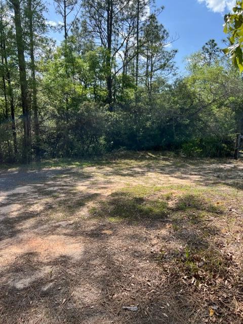 Vacant lot with small creek on backside that leads to adjacent lake. It would be a great place to place an RV for a weekend get away. Utilities in the area but fees are not paid. Property will require a septic tank.