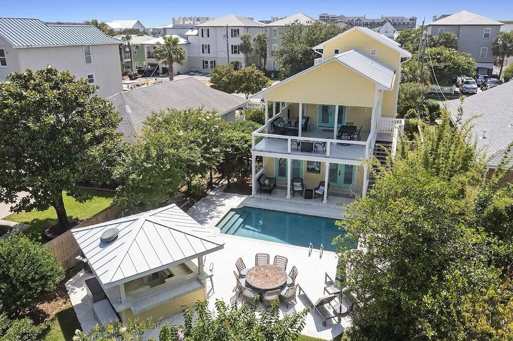 DREAMS ARE MADE OF THIS! ''Good Day Sunshine'', is situated half a block from the sugar white sands and emerald waters of Crystal Beach, this elegant coastal five bedroom, three and a half bath residence is tastefully updated, landscaped, and poised to become a new primary or secondary home, with exceptional rental income. The first-floor features low maintenance travertine floors with four bedrooms and two shared baths, with two bedrooms opening onto the pool area and a one car garage. On the second floor is an oversized living room with hand-milled walnut flooring, vaulted ceilings that open into an impressive chef's kitchen. The commercial-grade luxury kitchen with custom cabinetry has durable granite countertops, two Sub-Zero refrigerators, a large Wolf gas range and a wine fridge.