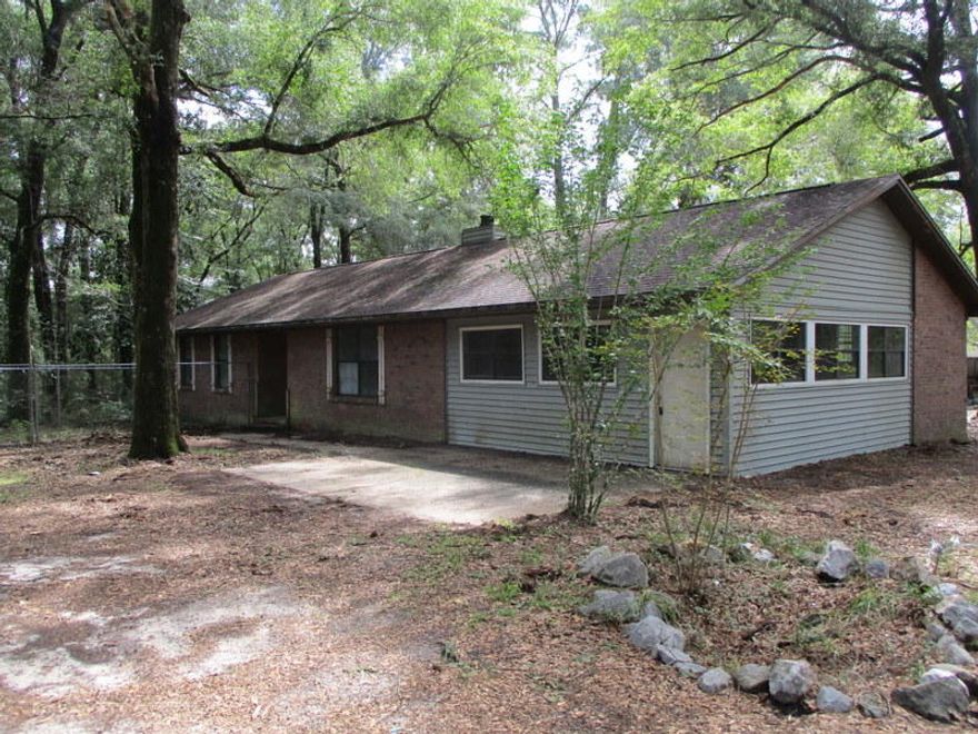 Located in the rural area of Laurel Hill West, this REO home has all brick exterior, enclosed garage, fireplace, galley kitchen and 3 bedrooms and 2 baths. Home is situated in the center of a larger 10 acre parcel with an easement to the home via Corey Rd. Home has tons of potential but due to repairs will not qualify for financing. Call today to set up your showing.