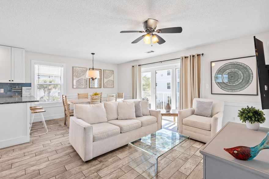 This three-bed, two-bath beach retreat is superbly located just three back from the white sandy beach. Attractively priced, it is fully updated with great potential as a vacation home or rental investment. Practical wood-look tile flooring and granite countertops give the entire condo a fresh, upscale vibe, along with well-appointed furnishings and neutral decor. Leave your car in your designated parking spot (one of two) right outside the door and head to the second floor. The open living room is spacious and bright, with multiple windows. The L-shaped floor plan includes a dedicated dining area for mealtimes after a full day's activities. There's a breakfast bar for additional seating. The kitchen comes fully equipped with stainless steel appliances and white Shaker-style cabinets. Granite countertops and a shiny glass backsplash complete the appeal. A Brand New washer and dryer are housed in a separate utility room, keeping everything neat and tidy. The generous sitting area invites you to relax on the comfy sofa and put your feet up in front of the TV. Enjoy refreshing breezes through sliding glass doors that open onto a balcony. It offers a private space where you can enjoy the views from an elevated vantage point. The balcony can also be accessed directly from the master bedroom with its ensuite bathroom and walk-in closet. There's a second bedroom with a queen bed, plus a bunk room with twin over full bunk beds. There's ample space for a trundle bed, too. A second full bathroom completes this spacious vacation retreat. Tennis courts, shuffleboard and a beautiful communal pool, keep everyone entertained when you're not swimming, walking and relaxing on the stunning sandy beach. Located midway between Seaside, Florida, and The Hub, this Beachside Villa retreat offers endless options for dining, shopping and entertainment, making every day feel like a true vacation. 
