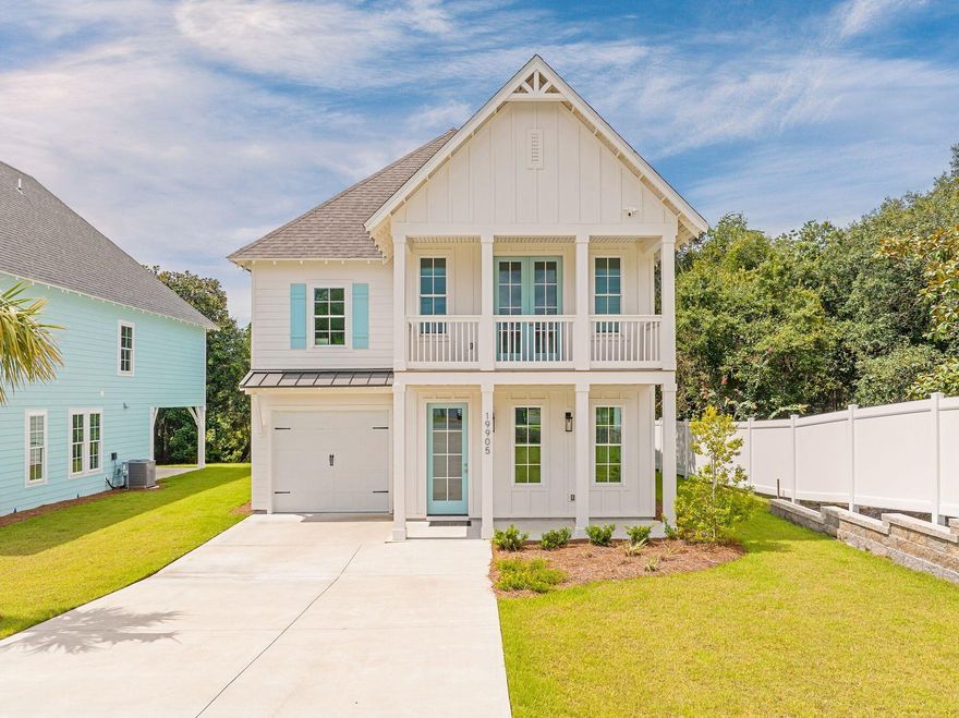 The Cottages at Laguna is a chic new development of luxury residences that deliver an enviable coastal lifestyle within easy reach of entertainment and amenities. Located at the west end of Panama City Beach, this quality new build by Holland Homes has great curb appeal with a wide driveway leading to a single-car garage. A full-width balcony sits above a covered front porch, providing areas for sitting out in the evening and watching the world go by. Step through the front door and take in the spacious open-concept floorplan beneath the airy 10-foot ceiling. Wood LVP flooring flows seamlessly from the built-in hall stand in the foyer, through the sitting and dining areas, to the island and gourmet kitchen to the rear. This fully furnished home features abundant windows with low sills, allowing an abundance of natural daylight to enter each designated space. The kitchen is a chef's delight with new stainless steel Whirlpool appliances, quartz countertops, a farmhouse sink, and plenty of storage in Shaker-style cabinetry. The gorgeous scallop-tile backsplash and gold fixtures display attention to detail that is the hallmark of this renowned Alabama builder. Rounding off the first floor, there's a walk-in shelved pantry, access to the garage, and a convenient half bath tucked beneath the stairs. A foyer leads to the first-floor master suite, offering step-free living if required. It has a beautiful private bathroom with a double vanity and a tiled walk-in shower. A rear glass door leads onto a generous covered porch overlooking the private rear yard. The second floor has four further bedrooms plus a bonus room or second living space for teens to hang out and watch TV. Bedrooms two and three share a Jack-and-Jill bathroom. In addition, there's a family bathroom on the landing along with a laundry closet. The second master suite has its own spa-like ensuite bathroom along with chandelier lighting, a shiplap accent wall, and French doors opening onto a private balcony. Shady palms and green turf surround this beach house, with the rear yard backing onto mature greenery. Available fully furnished, it's the ideal choice for full-time family living or short-term rentals. Public beach access is less than a half-mile away with shopping, dining, and Pier Park attractions just minutes from the door.
