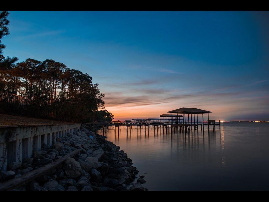 Estate Sized Bayfront Lot in Miramar Beach! At just over an acre with 100 feet on the bay, this lot is ready to build your own private estate! It is already partially cleared, with a boat dock, seawall, and water well for irrigation in place! Walton Way is a quiet dead end street that boasts numerous other private Bayfront Estates. This lot is ideally situated just minutes to Silver Sands, Destin Commons, or the Beach. And all with No HOA fees!