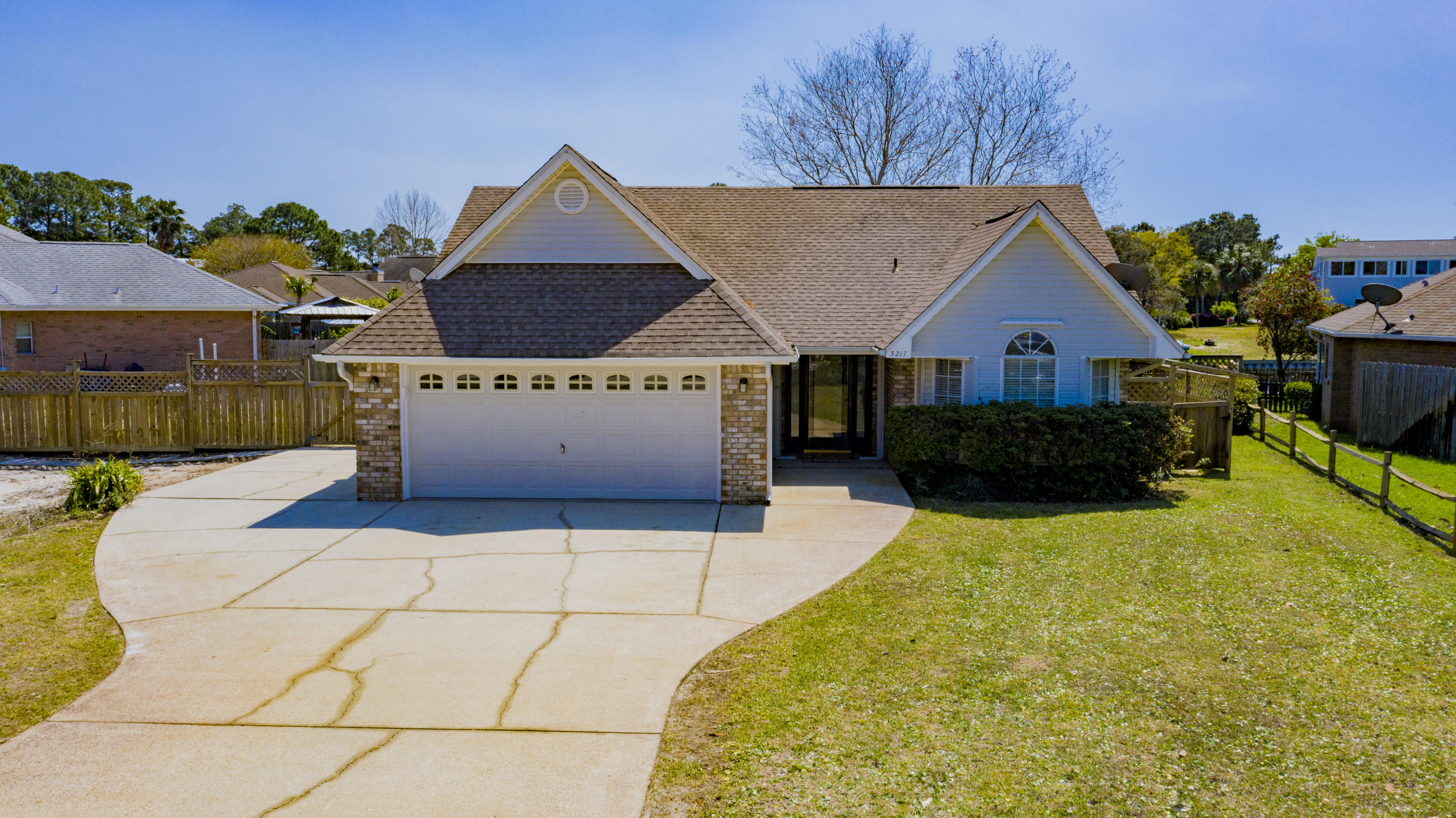 Located in Gulf Breeze, this canal front home has an open floor plan with vaulted ceilings giving for a nice spacious open feel. The kitchen comes fully equipped with stainless steel appliances, plenty of cabinet storage, breakfast bar and nook. With hardwood floors throughout the main living area, you'll also enjoy the wood burning fireplace with built in book shelves. This home is perfect for entertaining after a fun day on the boat with ample covered deck space with 3 exterior ceiling fans, a wash station. Enjoy enless sunsets and gorgeous waterfront views from your own back yard! This dock is fully equipped with a boat lift and boat house. The side yard has pleanty of room for trailer and RV parking. Feel secure knowing you have whole house hurricane protection. Don't miss your chance