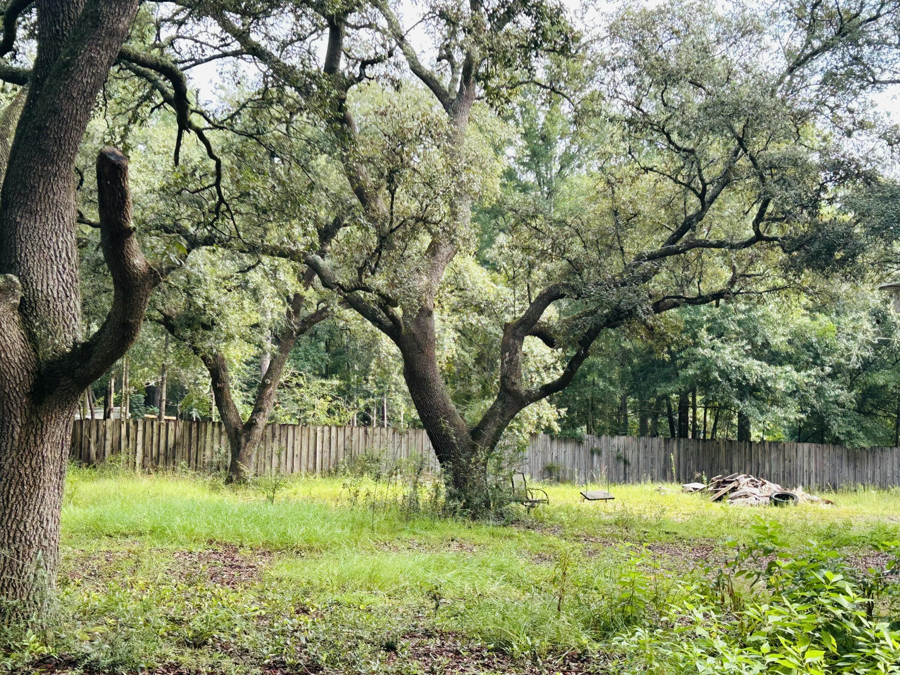 1.24 acres of improved land, corner lot zoned R1M off Hwy 87. Only 22miles to Navarre beach & 6 miles to I10. The lot is situated under a beautiful canopy of large mature Oaks, providing the feeling of quiet peaceful living with sounds of nature to relax to, while feeling the cool breezes blowing under the shade of the oaks. This property has a 400sq' tiny home. A 200-amp service pole is in place, and 2 FP&L halogen lights are on the property; city water and septic. Plenty of space for a Dream Home!