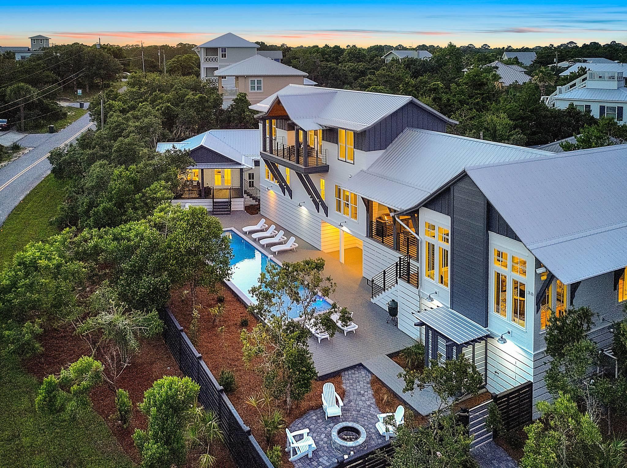 This unique urban designed home is a rental machine. This 30A custom home begins at 5,093 sq ft with gulf views from many rooms of the house! The incredible homes architect is Tyler Doin. The 5 bedroom/5.5 bath home w/ stand out exterior features makes this design a ''one of kind'' along 30A. No corner, trim, wall, or any other building detail was left untouched by Limbach Developments. This homes layout flows from room to room w/ details such as antique chestnut cabinets, copper niche and sinks, cantilevered streamlined bunk beds, waterfall silestone counters, and modern industrial concrete lighting. The large and inviting outdoor space includes a 12x50 ft. heated pool w/ a sun shelf. firepit, outdoor shower and large outdoor kitchen area and grill.