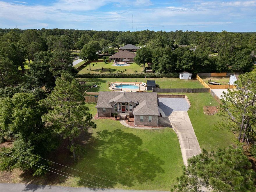 **Seller Offering Up To $5,000 to USE YOUR WAY!!  Closing cost, rate buydown, etc!!  !!Your North Crestview Oasis Awaits!! Discover this beautifully upgraded 3-bedroom, 2-bathroom gem nestled on a 1-acre lot in North Crestview. With 2,548 square feet of thoughtfully designed living space, this home is the perfect blend of comfort, style, and function.Step into your private paradise featuring an amazing in-ground pool complete with a brand new poolside cabana and luxurious high-end furniture--perfect for relaxing or entertaining in Florida's sunshine. The expansive, leveled parking area with a retaining wall offers ample space, including room for your RV. Enjoy ultimate privacy with a brand new privacy fence topped with a sleek privacy shade. Need space for hobbies or storage? This property delivers with 4 outdoor sheds, dedicated workshop, and plenty of room to roam.
Inside, you'll love the newly renovated master bathroom with elegant tile finishes and a spa-like feel. The kitchen boasts a new stainless steel refrigerator (conveys with the home), and the Florida room is climate-controlled with a mini-split system, making it the perfect year-round retreat.
Additional upgrades include:
*State-of-the-art water heater
*Smart security system for peace of mind
*Numerous modern updates throughout the home

This is more than a home it's a lifestyle upgrade. With everything already done for you, all that's left is to move in and enjoy your private North Crestview retreat.

Schedule your showing today paradise is calling!

