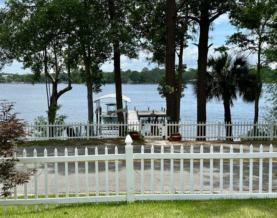 Welcome to your high-and-dry waterfront dream in the most sought-after location in Valparaiso! Beautiful views and deep-water, covered dock with boat lift. This property is very unique. Built in 1943 but completely renovated. No flood insurance required and no HOA. Lovely fenced back yard with blueberries, blackberries and some fruit trees. Huge 3-car carport with extra storage above and separate powered shop/shed/motorcycle garage on side of house. Quiet, friendly neighborhood right down the street from Lincoln park's beach and amenities, not to mention front row seats to the yearly 4th of July fireworks! If you'd like your own family compound, 2/1 house/lot behind main house is negotiable and will give you plenty of space to store an RV, Build a pool, or have extra income (currently rented for $1400/mo until September 1st). As you enter the home, you find an open floor plan with easy to maintain LVP and tile flooring. Ample light enters the huge high-impact windows that afford the incredible water views at front of house. The kitchen has marble countertop, stainless steel appliances and gas range! Master bedroom is huge and can accommodate a sitting area and has an en-suite master bath and walk-in closet. In back of house you will find the guest suite with its own bath and private entrance and another bedroom currently being used as a den. Come look at this home today and make it yours!