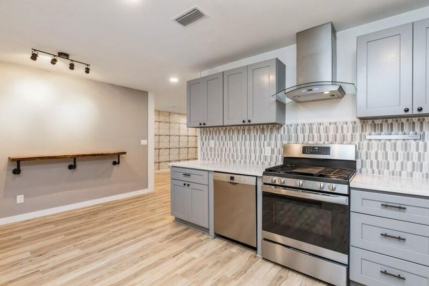 Adorable Florida cottage with rustic charm in the heart of Shalimar!  Screened porch overlooks the shady backyard-includes doggie door!  Completely renovated with luxury vinyl plank flooring throughout, granite countertops, stunning tile backsplash, live-edge wall bar, stainless steel appliances, gas stove with glass hood, barn door feature, interior shiplap siding, blinds, steam punk built-in shelving, electric fireplace-no wood needed! Primary bedroom features bath with walk-in shower, custom tile work & granite vanity!  No stairs! Laundry closet with ventless dryer connection!  Whole-house generator included! Bahama shutters for facade & panels for remaining windows.  Fenced backyard! Metal roof!  Shed needs work & conveying AS-IS.