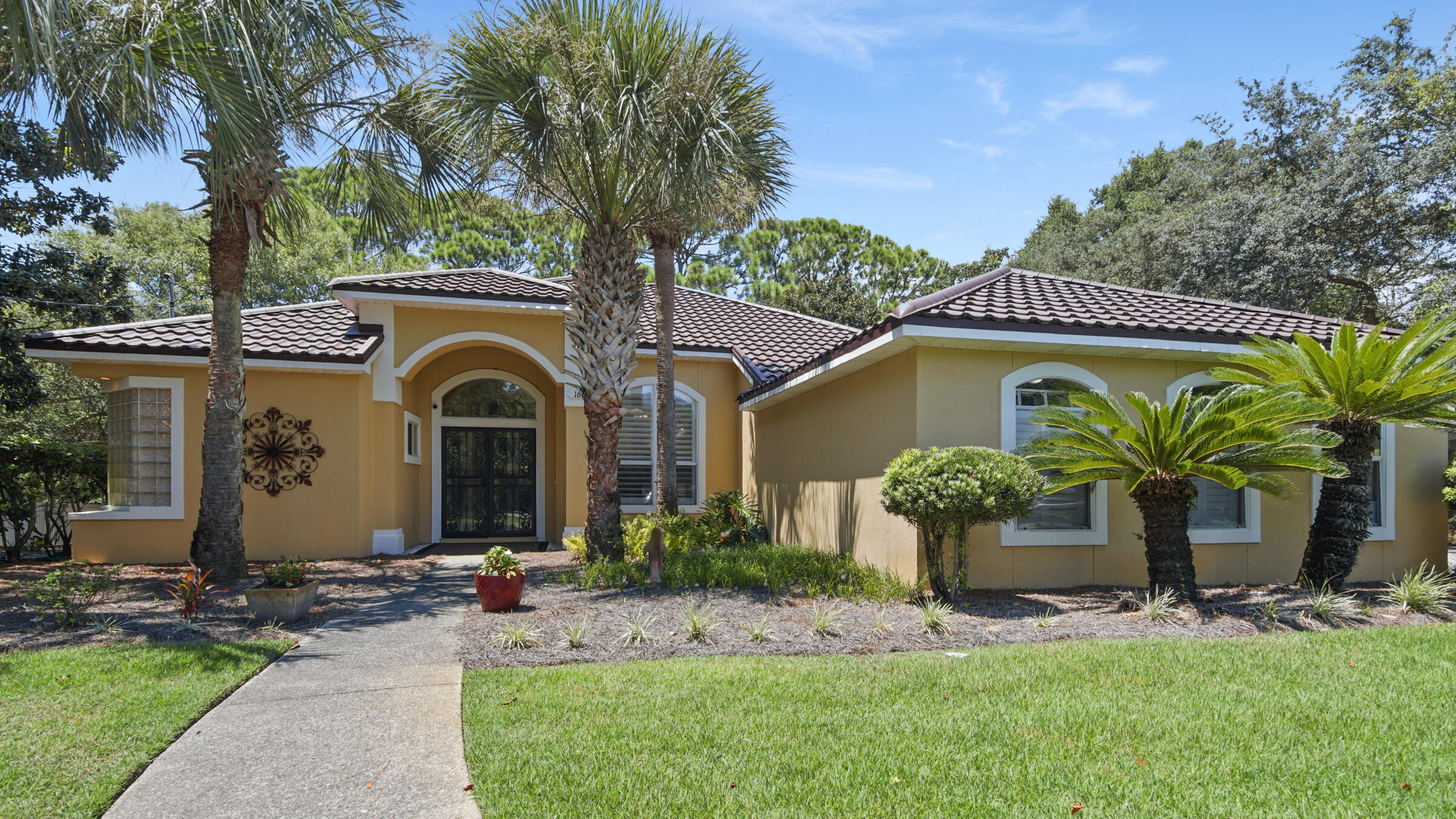 This Gulf Pines 4-bedroom, 2-bathroom lakefront home offers 2,338 square feet with deeded beach access. Enjoy life on the water with a serene backyard setting, complete with a new dock. Just a quarter-mile away, you have convenient and private beach access for endless coastal enjoyment.Inside, an open floor plan connects living areas seamlessly. The multiple living spaces open up to the kitchen and breakfast dining area, as well as boasting a formal dining area with plantation shutters. A convenient screened-in porch can be accessed from multiple areas in the home.Practical features include a 2-car garage with a third space for the Yamaha golf cart that conveys with the sale, a reliable generator, and a partially furnished interior.