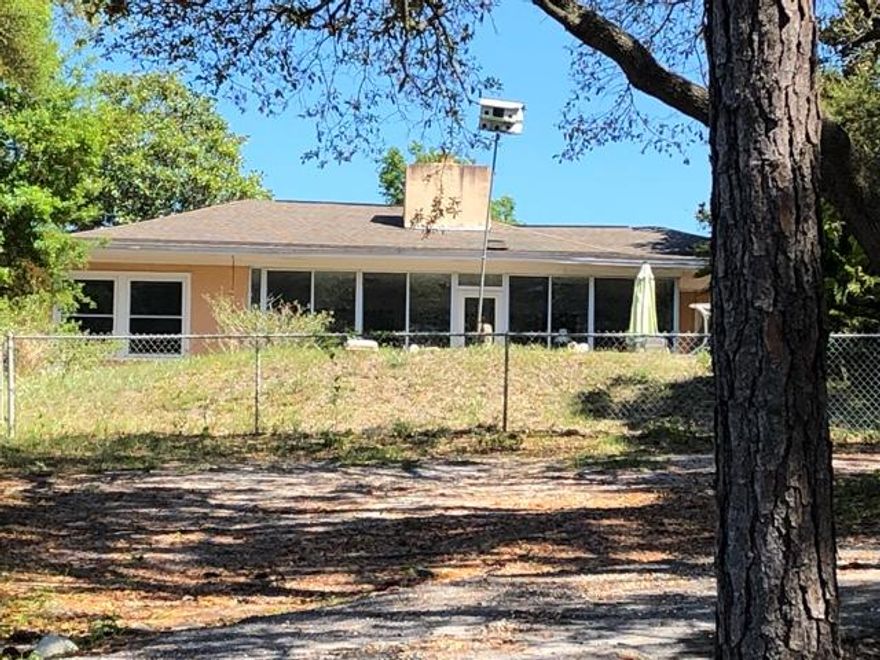 A rare opportunity to own a home on Joe;s Bayou. Large home in need of TLC but offers some great features. Florida Room overlooking pool area,, Two large Master Bedroom Suites, Two additional large bedrooms that share a bath,. Small office off kitchen could be additional bedroom if needed. 10 foot ceilings in living room, dining room, and foyer with nine foot in bedrooms. Some Improvements include new high impact windows installed two years ago except in Florida Room, and Whole House Generator. Home has original hardwood flooring in living areas except Florida Room.