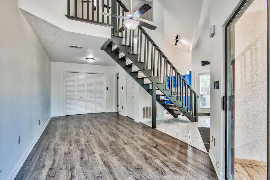 Fantastic 1-bedroom, 2-bath townhome nestled just off Mack Bayou on the canal with NO HOA FEE! This unit has been beautifully updated with luxury vinyl plank flooring in the living area & bedroom. The spacious living area has direct access to a large, partially covered deck, perfect for entertaining outdoors. Upon entering, you are greeted with vaulted ceilings which really give the unit an open & spacious feel. The floors are easily maintained with no carpet, ideal for beach living. The kitchen features custom cabinets with plenty of space for storage. The full bath downstairs is convenient & nicely updated with tile floor & a new walk-in shower & vanity. Upstairs features the spacious bedroom with a high ceiling, en suite bath, & luxury vinyl flooring.