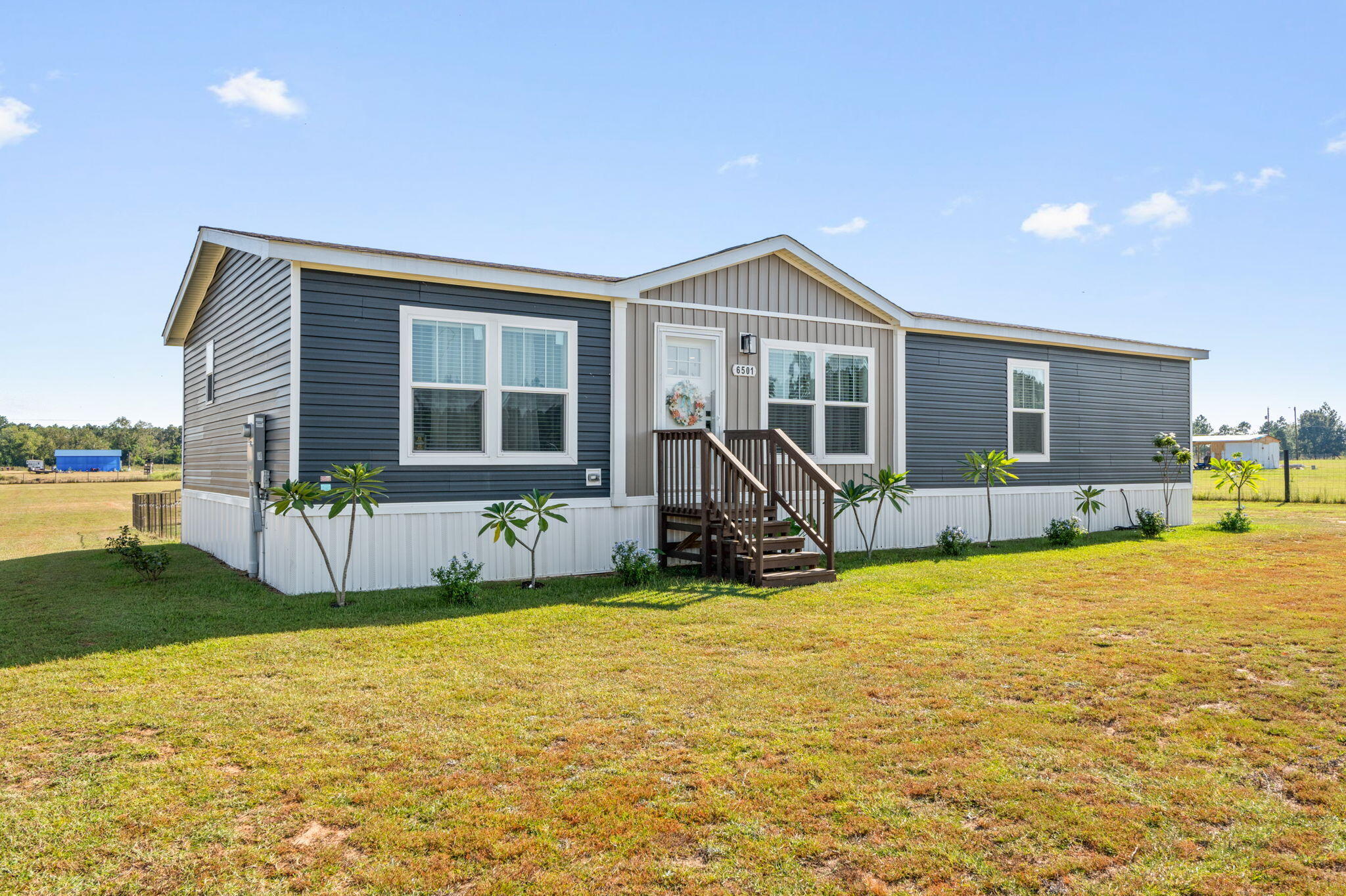 Almost 2 acres out in the country. Like new manufactured home that is sparkling clean and move in ready. From the moment you step in the door you see how spacious and open this home is. The living room is a fantastic size and flows to the dining room and kitchen. The kitchen is amazing with a large island and lots of cabinets. The dining room overlooks the back yard. There is a great sized laundry room off the kitchen. The primary bedroom is a good size and has a big walk in closet, double vanity and shower. Split floor plan. The acreage is cleared and has a new storage shed. Plenty of room to build a pole barn or workshop, plant fruit trees, grow a huge vegetable garden and raise chickens! There are endless possibilities with this property!