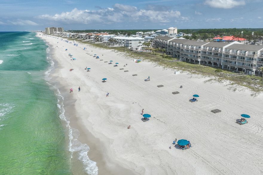 Enjoy panoramic gulf views from this well-maintained condo located in the bijou development of Ramsgate Harbor. One of just 66 units, it has two gulf-front balconies overlooking 550 feet of prime beachfront. The sight and sound of the gently turning waves deliver a sense of living right on the beautiful Gulf of Mexico. This modern condo has parking under the building. The main living space is on the first floor, delivering superb views from the elevated position. Tile flooring, strategically placed mirrors and tasteful decor provide a sense of light and space in the open floor plan. The kitchen is fully equipped with a black stove and stainless steel appliances. Overhead wall cabinets above the breakfast bar provide ample extra storage and stools are lined up for breakfast to supplement the formal dining area. There's a neat half bath, laundry and additional storage under the stairs. At the end of the day, the well-proportioned sitting room provides a cozy space to relax, but all eyes will be drawn to the stunning gulf views through a wall of sliding glass doors and windows. Step onto the balcony to appreciate gentle breezes blowing playfully onshore as you dine or read in this private outdoor haven. Upstairs, this spacious beach home has two generously sized bedrooms and two bathrooms, both with a tub/shower combo. The sophisticated master suite has breathtaking gulf views to wake up to. Sip your morning coffee on the upper balcony and enjoy tranquil moments heralding each new day. Guests are accommodated in the second bedroom with ample space for a queen-size bed and a set of bunk beds. Owners and guests can spend the day at the community pool or make use of the beach chair service on the powder-soft white sandy beach. For over 30 years, this well-maintained condo has been used as a family vacation home and was never rented until recently. Further afield, championship golf courses, sunset cruises, fishing charters and a trampoline park beckon, along with shopping and dining nearby.