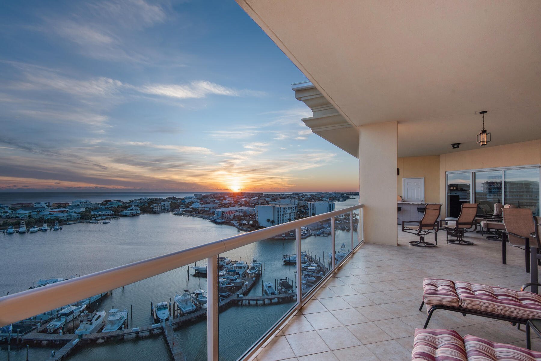 Experience the elegance of Harbor front living in this spacious Penthouse 2 in Marbella Condominium in Destin, Florida. This elegant unit is well appointed and owners have paid attention to every detail of this premier Penthouse with multiple improvements and renovations including custom cabinetry, fine finishes, gourmet appliances, custom window treatments, new flooring with Pergo Luxury Vinyl Plank throughout, light fixtures, door hardware, custom built outdoor kitchen on the spacious large balcony, and many more. Two ACs recently replaced. The gourmet kitchen is a chefs dream and excellent for entertaining family and friends. Both the two harborside master suites have stunning views of the harbor and gulf. The two large guestrooms have bay views and have their own private baths.