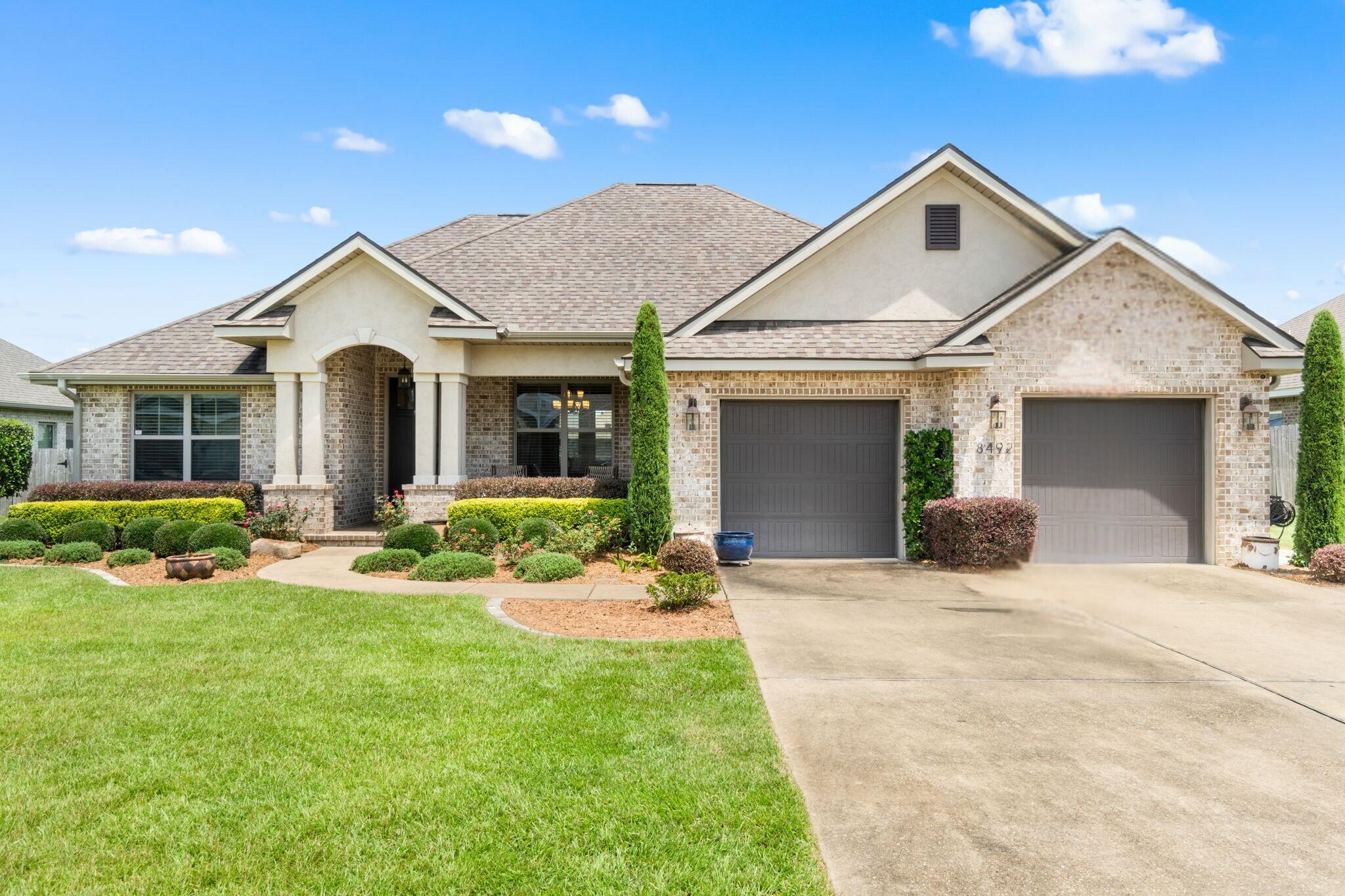 Welcome to this meticulously maintained and thoughtfully updated 2017 built home nestled in the Twenty One Oaks subdivision in the Beulah area of Pensacola. This beautiful property offers a split floor plan and features wood-look tile flooring throughout all common and wet areas, as well as an open concept layout that seamlessly connects the dining room, spacious living room, and the kitchen - highlighted by a crown-molding lined tray ceiling in the living room to add a sense of style and elegance. The kitchen offers stainless appliances - including a gas powered stove, granite countertops, a wet island, ample cabinetry, a breakfast nook with a view of the backyard, a separate pantry for storage, and direct access to an interior laundry room for added convenience. Step outside to your very own backyard oasis retreat - complete with a built-in outdoor kitchen grilling area, sparkling pool with sun shelf - perfect for kiddos or catching a tan, fire pit, and a shaded pergola - for the best spot to relax while outdoor entertaining. Back inside, the primary bedroom with spa-like ensuite features a double vanity, soaking tub, separate tiled walk-in shower, water closet, and the most amazing walk-in closet with custom built-in shelves/organization system. Schedule your showing TODAY and check it out for yourself!
