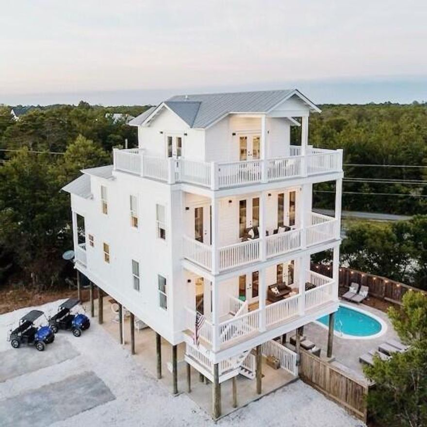 This beautiful, newly remodeled beach home on 30A is your dream vacation destination. From here you're just a 3 minute golf-cart ride away from the powder white sands and turquoise waters of the Emerald Coast. This over Half acre lot with no HOA as endless possibilities. This 5 bedroom/4 bathroom home can accommodate up to 25 people. On the first level is a large seating area with a flat screen tv, and a private pool that is heated. On the second floor (the main level) you'll find a fully equipped kitchen with beautiful quartz countertops, custom cabinets and new appliances. This area is perfect for entertainment as the kitchen opens to the spacious dining room and living area. From the balconies you can enjoy breathtaking views of the Gulf over Topsail State Park.