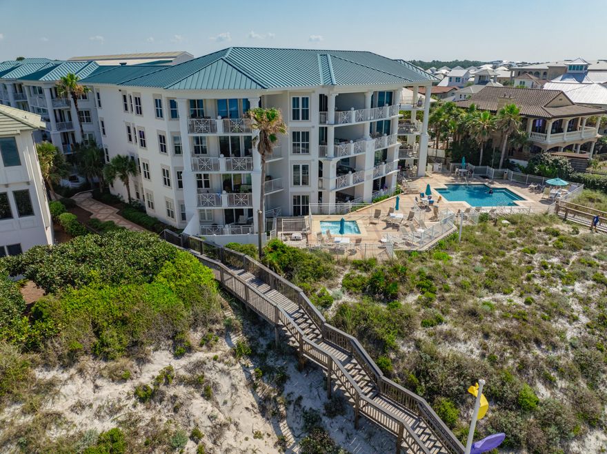 Blue Mountain Beach condo has Private Beach w/Gated Access & seasonal beach services! A hidden gem for those seeking solace in the shimmering waters of the gulf.  Inside you'll be greeted with modern elegance. The kitchen is adorned with granite, S/S appliances and pendant lights. Attractive new light-colored wood plank floors throughout; recently painted; new furnishings. Furnishings do convey!  Inviting spacious balcony. Split floorplan- master en-suite enjoys personal balcony; Stacked washer/dryer hall closet. New Sliding Doors/Windows installed. Dec 2024.  Water heater replaced in 2017.  Covered parking & elevator. Fitness center onsite. Pool and hot tub offer a retreat overlooking the beach. On rental program.  Resort living with entertainment, dining, and shopping options~