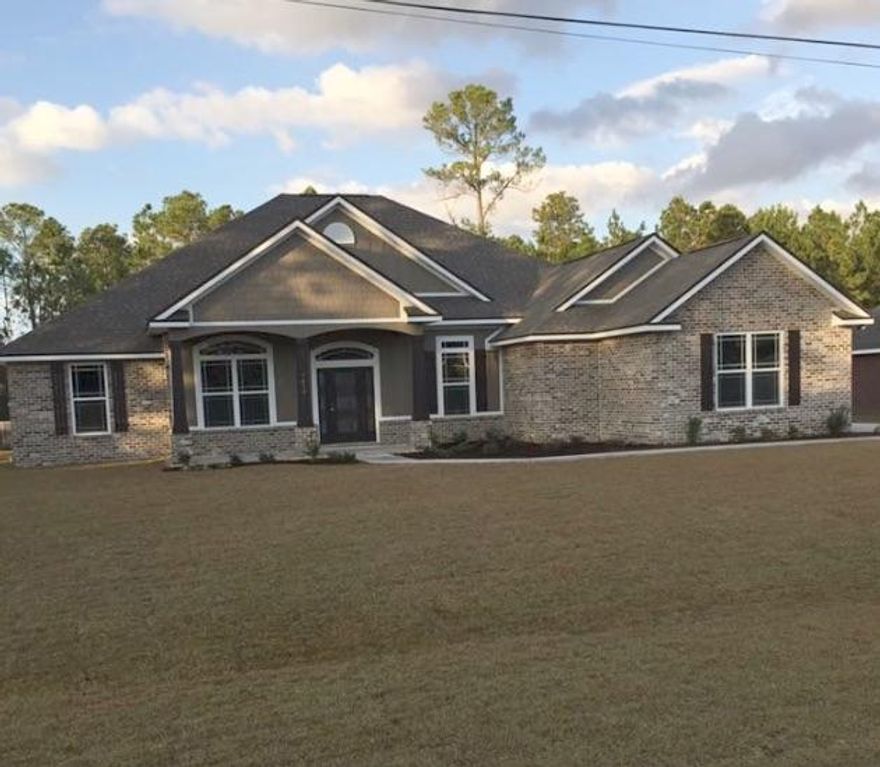 Craftsman Style executive home in Navarre, 4 bed, 3 bath home is perfect for entertaining. The vast open space of Great Room area features hand crafted Double Trey Ceiling and Wood Plank Tile flooring in all Common and Wet areas. Gourmet Kitchen boasts gorgeous Granite Countertops, Tile Backsplash, Whirlpool Gold stainless steel Appliances, Apron front Kitchen Sink, 42'' Upper Cabinets, and a large island with a Prep Sink and Pop up Outlet in Island, 2 Pantries. The expansive Master Suite features a Trey Ceiling, Sitting Area and Sliding Barn Door Stained with Glass to Master Bath, while the Master Bathroom has Double Granite Vanities,