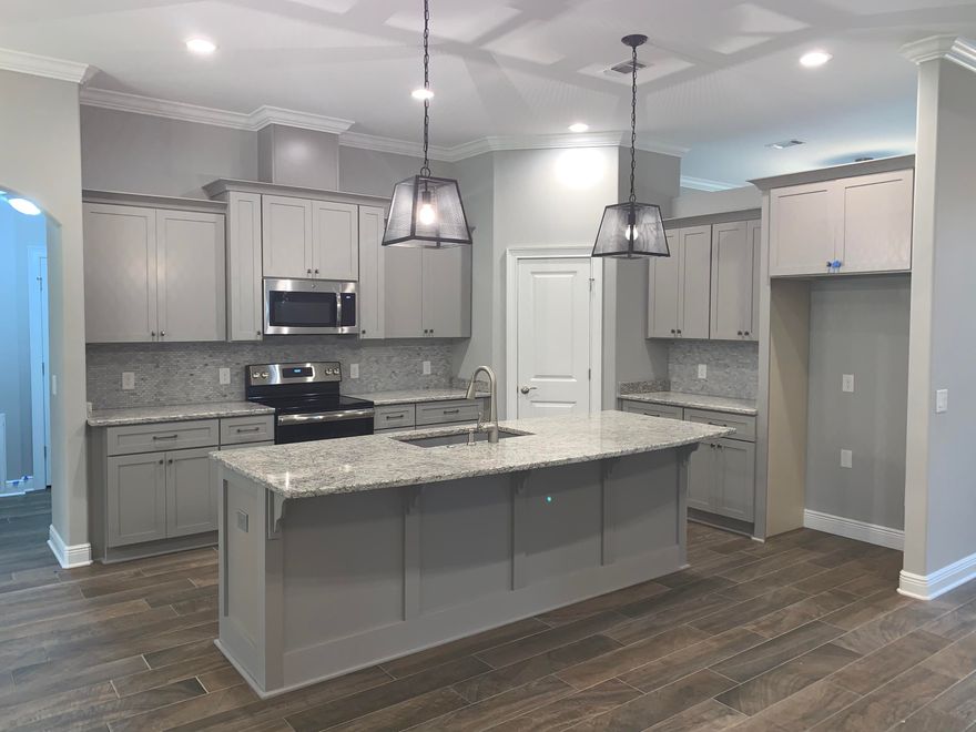 NEW CRAFTSMAN Custom Built Home in Holley By The Sea,Enjoying all the Club House amenities including :Pools,Fully Equipped Gym,Tennis Courts,Waterfront Park & Deeded Access to Santa Rosa Sound This luxurious 4 bed/3 bath Tri split floor plan is under construction...and will be ready in time for your Early Fall move in ~Desirable Location within HBTS..with easy access to Navarre Beach, shopping and Hwy 98 to Hurlburt Field AFB.This Stunning Robbins Builders Custom Home~offers trend setting design & features~Greeted by a walk in foyer open to the Formal Dining and Office with double glass doors/sweeping through to your open floor plan ~Large Gourmet kitchen enjoying custom Shaker cabinets with crown molding beautiful granite counter tops~Tiled Back splash~ Under Mount Sink~S/S Appliances~ ~Center Island with open flow to the breakfast nook and family room, Wood Plank Staggered Tile through the foyer,dining room, main living area, laundry and bathrooms. Large Master with trey ceiling & ceiling fan. Master bath offers a large tiled walk in shower /separate soaking tub~Granite double vanity with brushed nickel fittings/picture frame mirrors & Huge walk in closet.Two additional bedrooms are a great size with ~ ceiling fans and share a large Jack'n'Jill bathroom with separate closed off vanity /dressing areas and joint step in tub/shower and WC.Third additional bedroom is separate from the other rooms and would make a perfect guest/teen suite with its own bathroom and access out to the large covered porch.Laundry room is very spacious with a recessed area to accommodate an additional refrigerator or storage shelves...flows through to the over sized 3 car garage 31 x 23...ideal for the larger trucks and still plenty of room for all the outdoor toys. Home is situated on one of the larger lots with grassed yard'~ privacy buffer~sprinkler system~ lawn pump and well with digital programmable timer for easy care. TAEXX in wall pest control system~ Fabric Shield Hurricane protection and dimensional shingle roof for lower insurance premium. Upgrades include crown molding, bull nose corners ,knockdown ceilings, recessed lighting ,framed mirrors, deluxe lighting package,50 Gallon water heater, garage door remotes, attic drop down stairs~ to name a few......Click on the link in the photos and experience a 3 D tour of the home ...Call today for further information ,colors and construction status.Please note pictures are of a previous build so colors and finishes may vary.