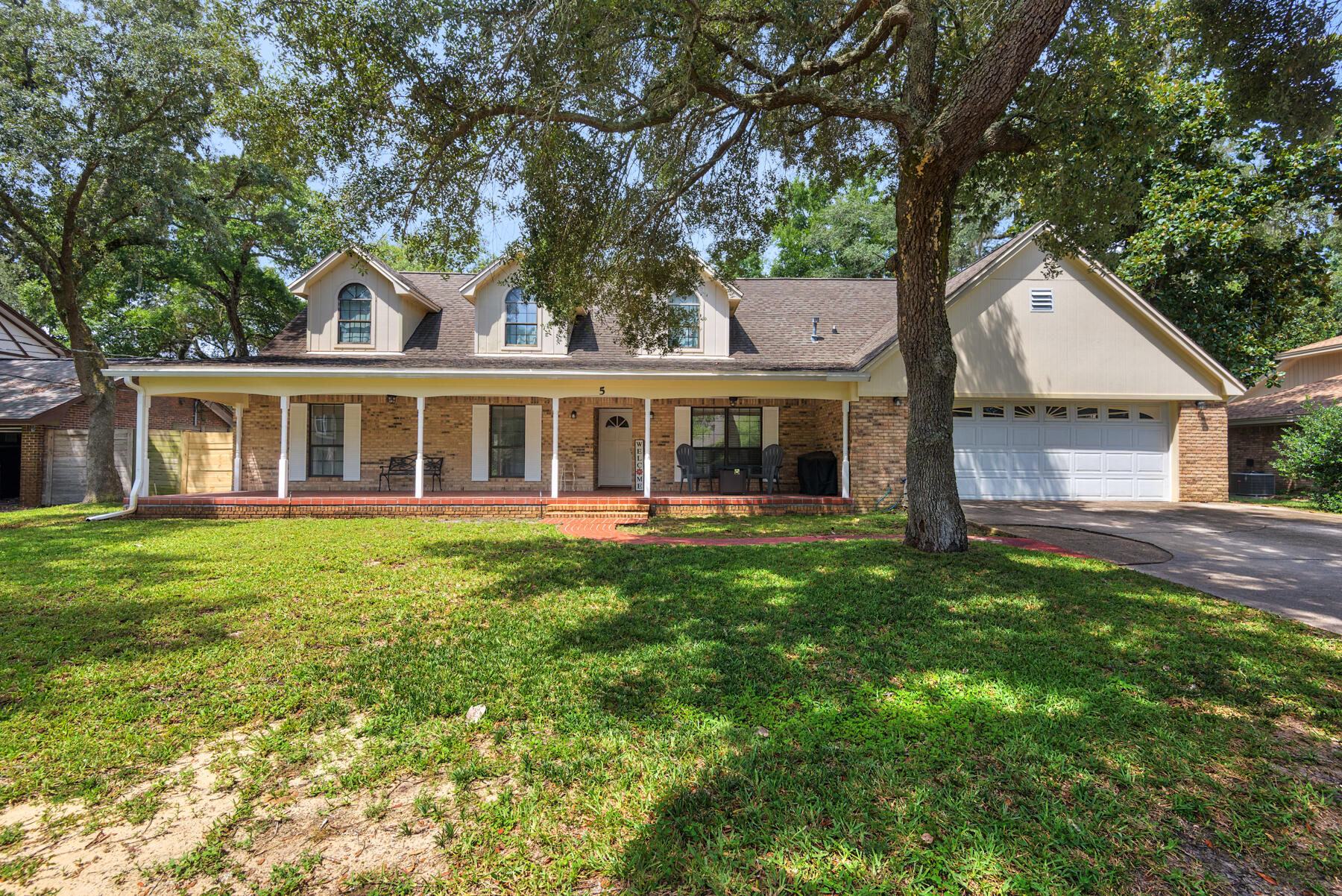 Welcome to 5 Shady Lane, a 3,241 sf custom-built home with huge potential in one of the area's most desirable locations. Surrounded by mature oaks, this property already offers great bones: vaulted ceilings, custom built-ins, a spacious great room with a brick fireplace, and a main-level master suite. Upstairs, a massive bonus room adds flexible living space--perfect for an additional bedroom, family room, or home office. The oversized two-car garage with workspace, private back patio, and charming covered front porch add even more value. Plus, enjoy deeded Sound access at the end of the street perfect for launching a kayak or paddleboard. Priced well below appraisal, this is a rare chance to update, customize, and build equity while creating your dream coastal retreat. Come see it today!