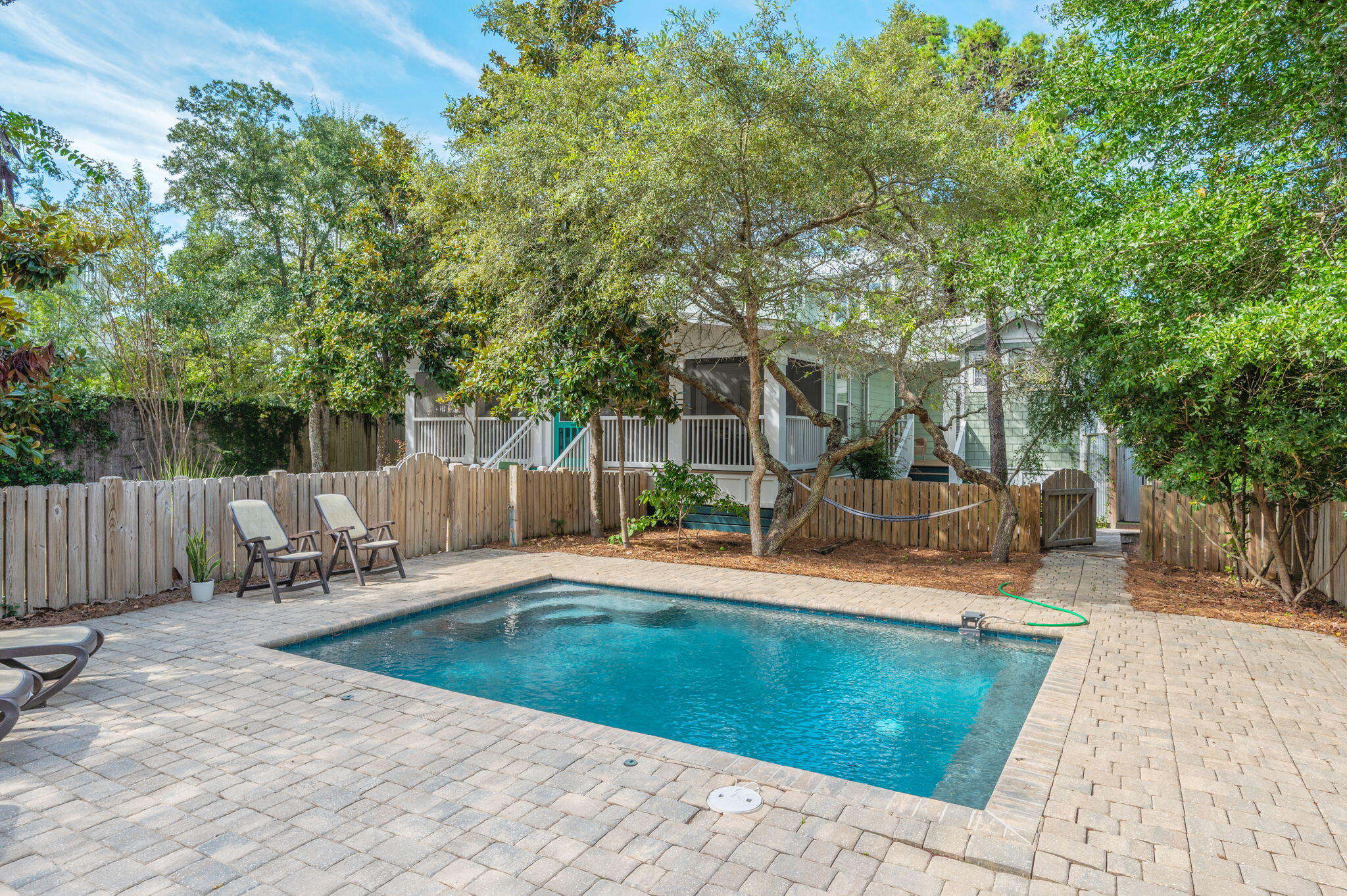 ''Close Enough'' is located in Seagrove Beach literally minutes from Seaside's Town Center where dining, shopping, and entertainment await, and only 2 blocks from the Dogwood/Thyme Street beach access. This adorable home started as a 1 bedroom 1 bath with only 864 sq-ft. Maintaining its Old Seagrove' charm, the home was completely renovated in 2010 and boasts a large screened front porch, 2 first floor master suites each with private entrance, deck, and outdoor shower; a third ensuite guest room and a spacious loft with twin beds and a second living area on the second floor. For outdoor enthusiasts, enjoy dining on the grill deck, unwind by the large heated pool, or relax in the hammock under the trees. When it's time to go to the beach, all your gear is in the ample storage building and golf cart awaits in the separate garage to explore all of 30A. "Close Enough" sits back from the street allowing privacy and enjoyment of the natural landscape. This compound-like property's oversize lot provides abundant parking and the option to add a carriage house, enhancing its appeal and potential.