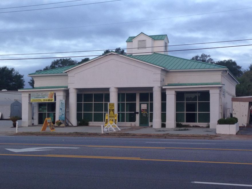 Located on Eglin Parkway with parking on the side and rear of the building. The unit is configured with two rooms located at the front of the building that could be used for a sales counter/office/reception area etc. Behind the two rooms is a large room with high ceilings and exposed wood trusses.