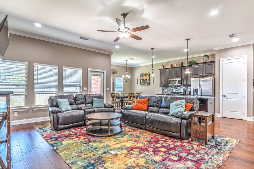 Motivated sellers reduced price by $10,000. Price is firm. Meticulously maintained Craftsman style home inside and out. Minutes from Eglin and centrally located in Niceville. This all brick home is located on a corner lot in a small neighborhood featuring 7 homes, underground utilities, natural gas, sidewalks and a lovely pond. Open floor plan concept with beautiful hand scraped HARDWOOD FLOORING, state of the art, open kitchen with a center working island, GAS RANGE, beautiful wood cabinetry with soft close drawers, GRANITE COUNTER TOPS, STAINLESS STEEL APPLIANCES, INCLUDING THE REFRIGERATOR, and lovely TILED back splash which opens to the large family room. A flex room, with French doors, could be an office, dining room or study.