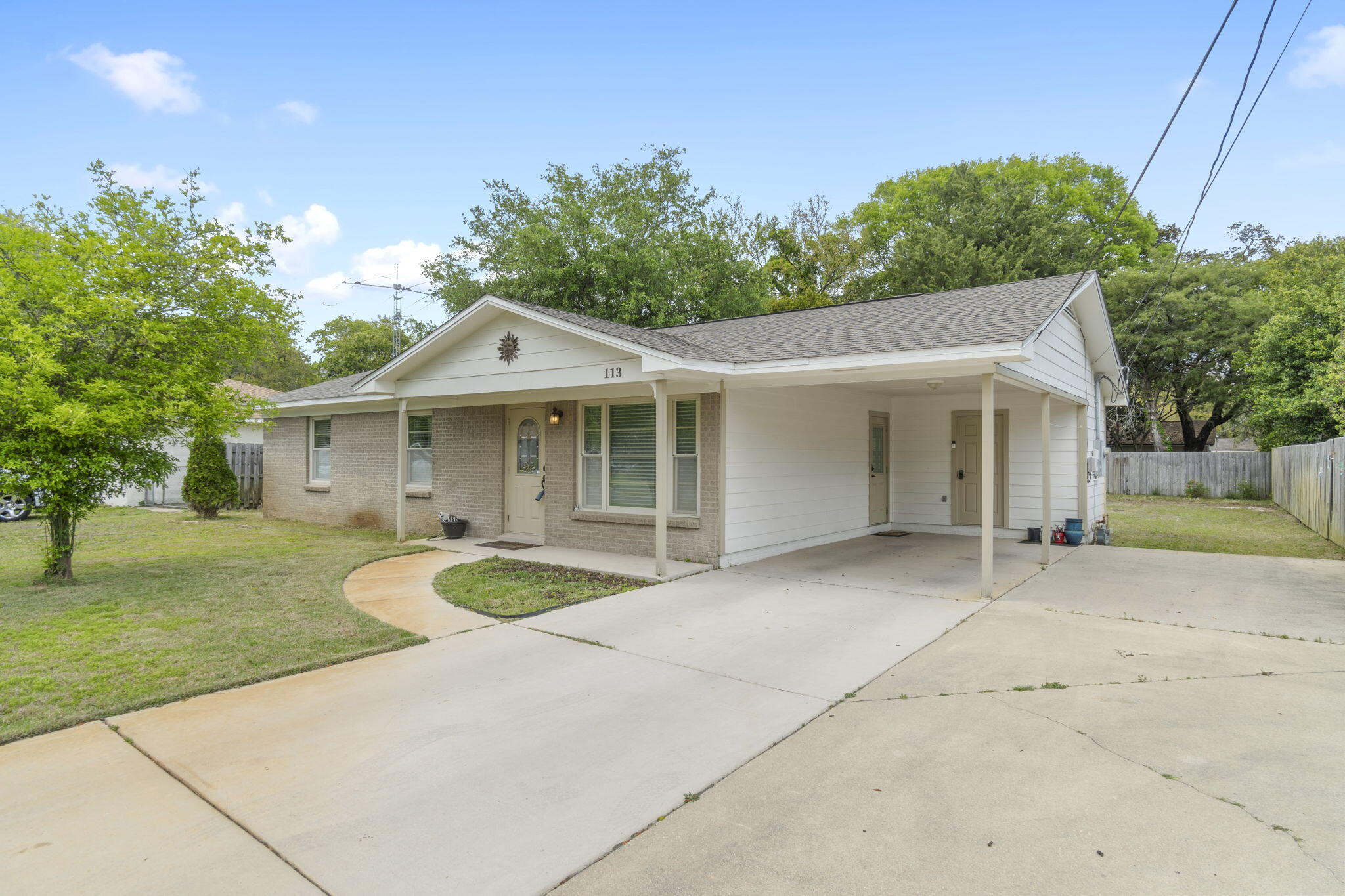 Adorable, immaculately maintained 3 bedroom 1 1/2 bath home in the heart of Fort Walton Beach! Drive up to this brick and hardi-board home with covered front porch, carport with two parking spaces PLUS an additional driveway with two more parking spaces providing room for boat or RV. The partially fenced lot is large almost 1/4 of an acre providing plenty of room for a swimming pool. The backyard also a paved patio and 8x16 shed. Speaking of an RV....the backyard has 30 AMP electric service and sewer taps. Inside you will find warm and cozy living space with an updated kitchen with maple soft close cabinets and granite countertops. Stove/oven can be gas or electric. Recessed and pendant lighting, LVP floors and no popcorn ceilings make this home feel modern. The bathroom has been updated with a large walk-in shower, maple soft close cabinetry and medicine cabinet. A half bath attaches to the master. Work from home or need extra storage? The attached 7x10 storage room with electricity is an added bonus! Custom window blinds by Levelor, as well as refrigerator with ice maker, electric stove and built in microwave convey with the home. The location is absolutely fantastic being walking distance to the Fort Walton Beach Rec Center with pickleball and many other activities. Since 2010, the windows have been replaced with double pane, tilt in windows; insulation was added to the walls and the exterior hardiboard was replaced. The attic ductwork was also replaced. The roof is 2019. HVAC 2008. Gas water heater 2013. Schedule your showing today!